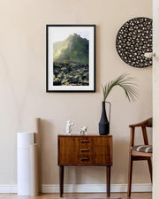 Modern interior with a wooden side table, framed artwork, and decorative items.