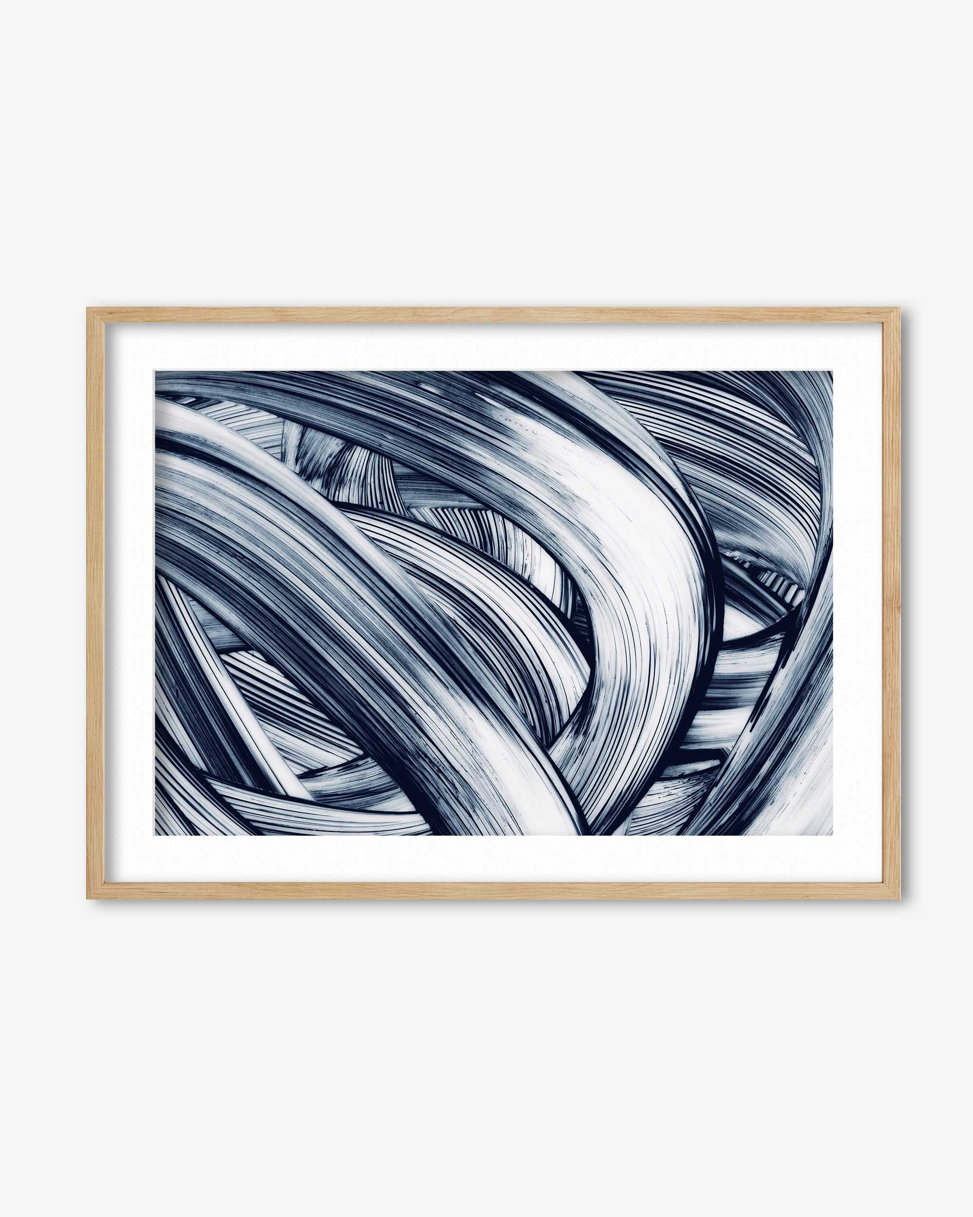 Framed abstract art print with wavy lines in black and white on a white background