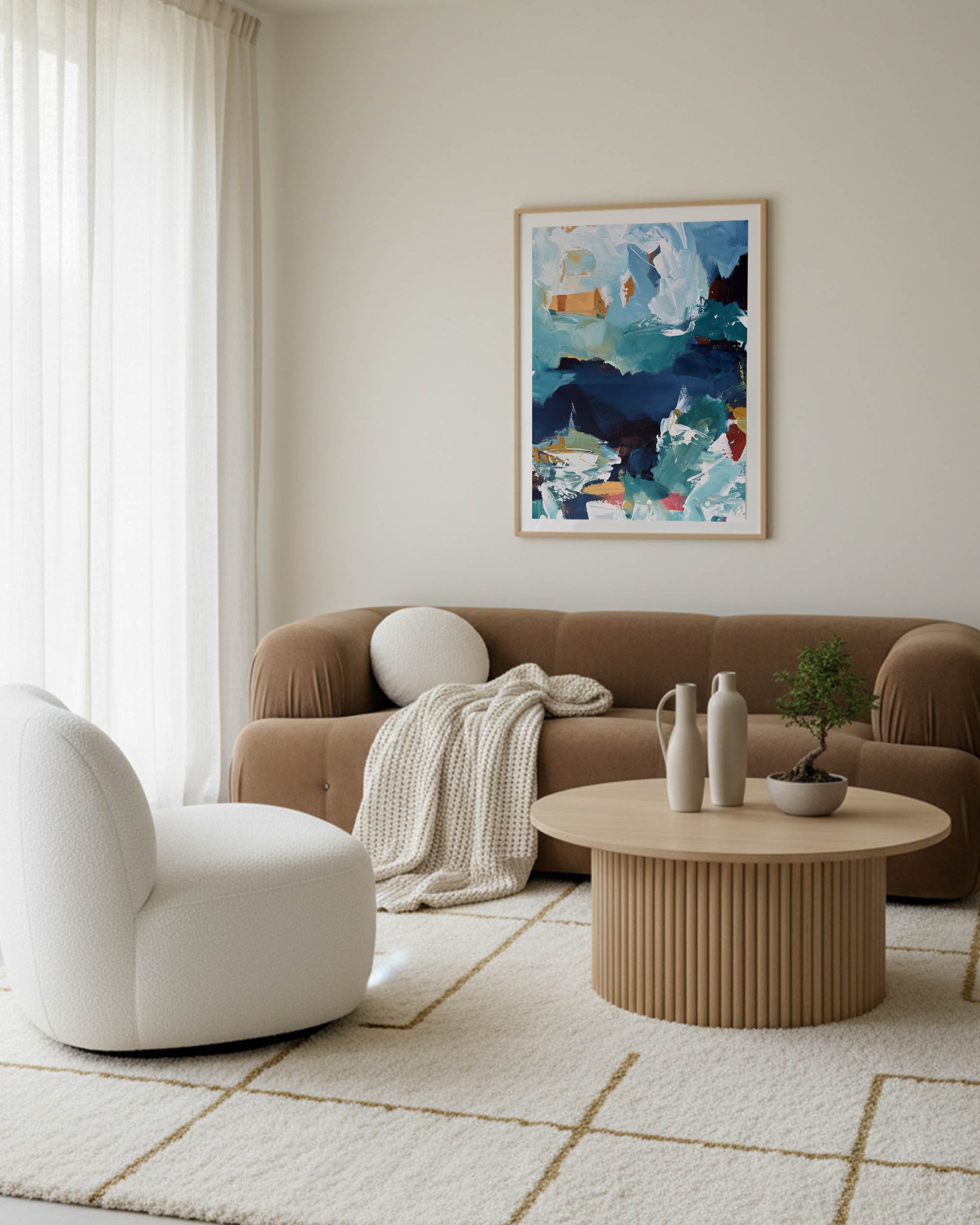 Modern living room with a brown sofa, white armchair, and abstract painting on the wall.