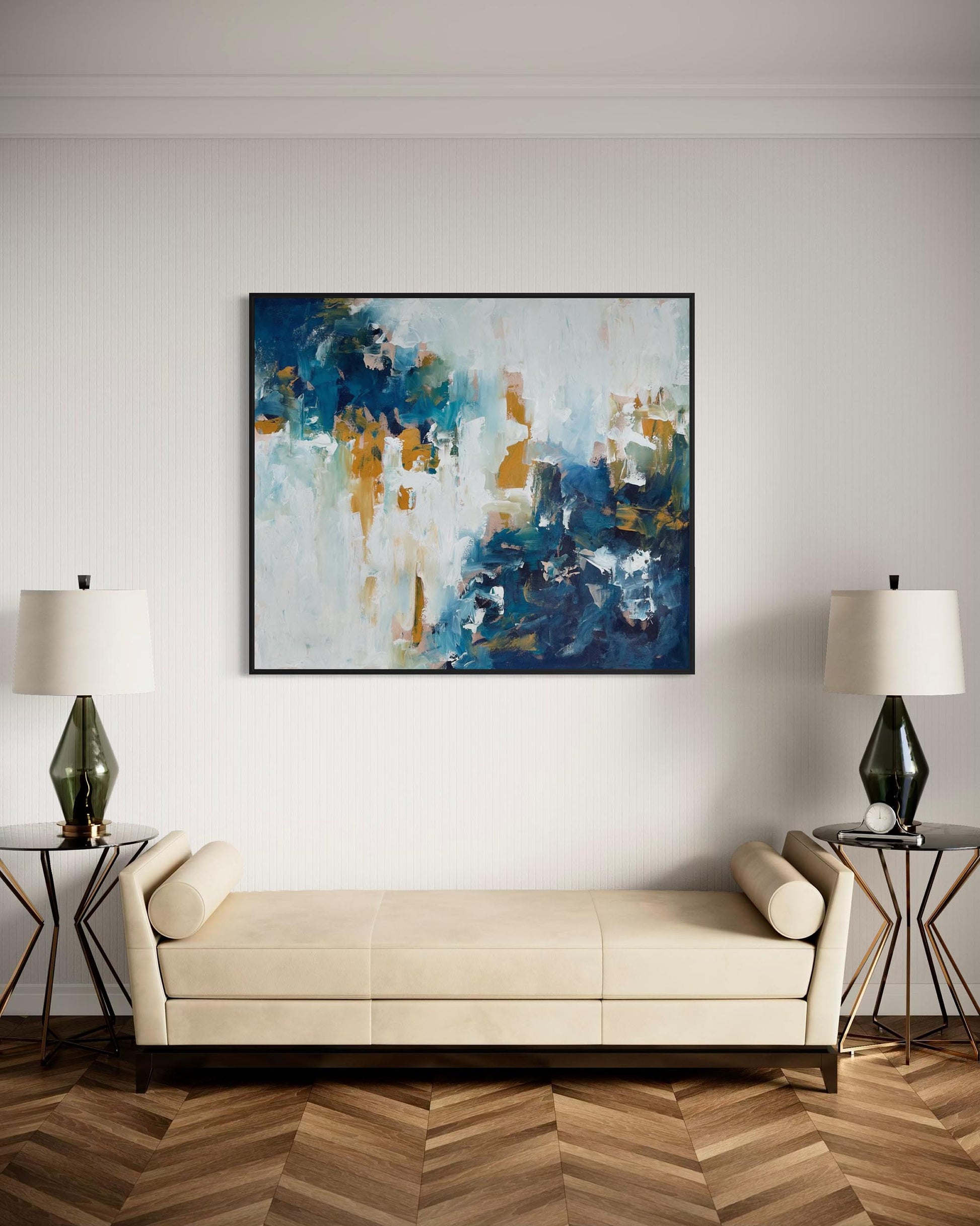Modern living room with abstract painting, beige sofa, and side tables.