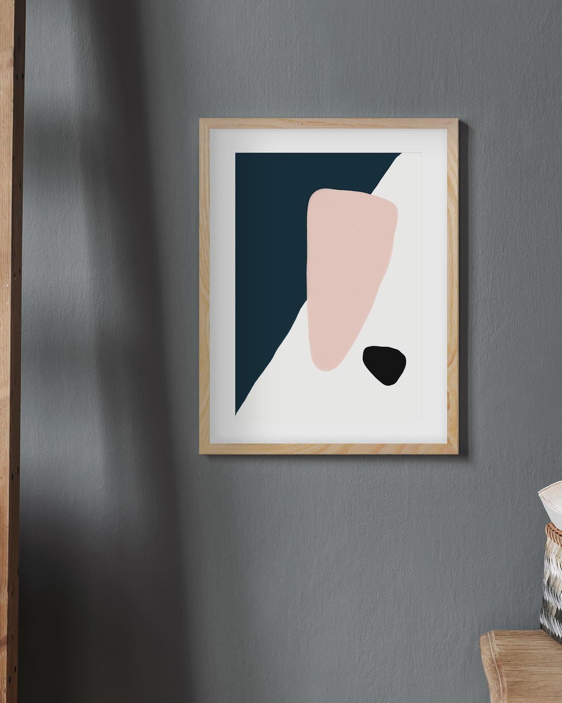 Framed abstract art print on a gray wall