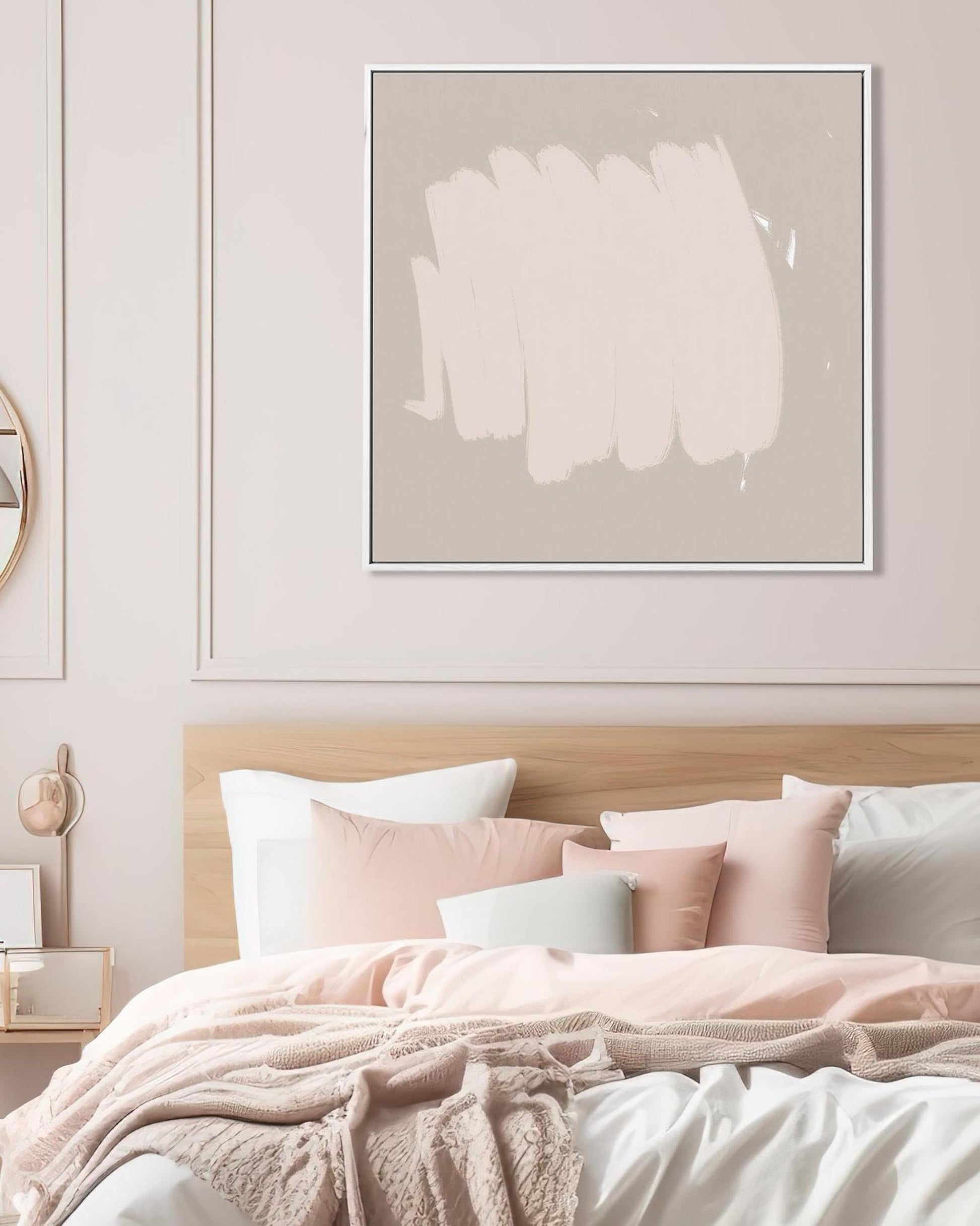 Bedroom with pink bedding and abstract art on the wall