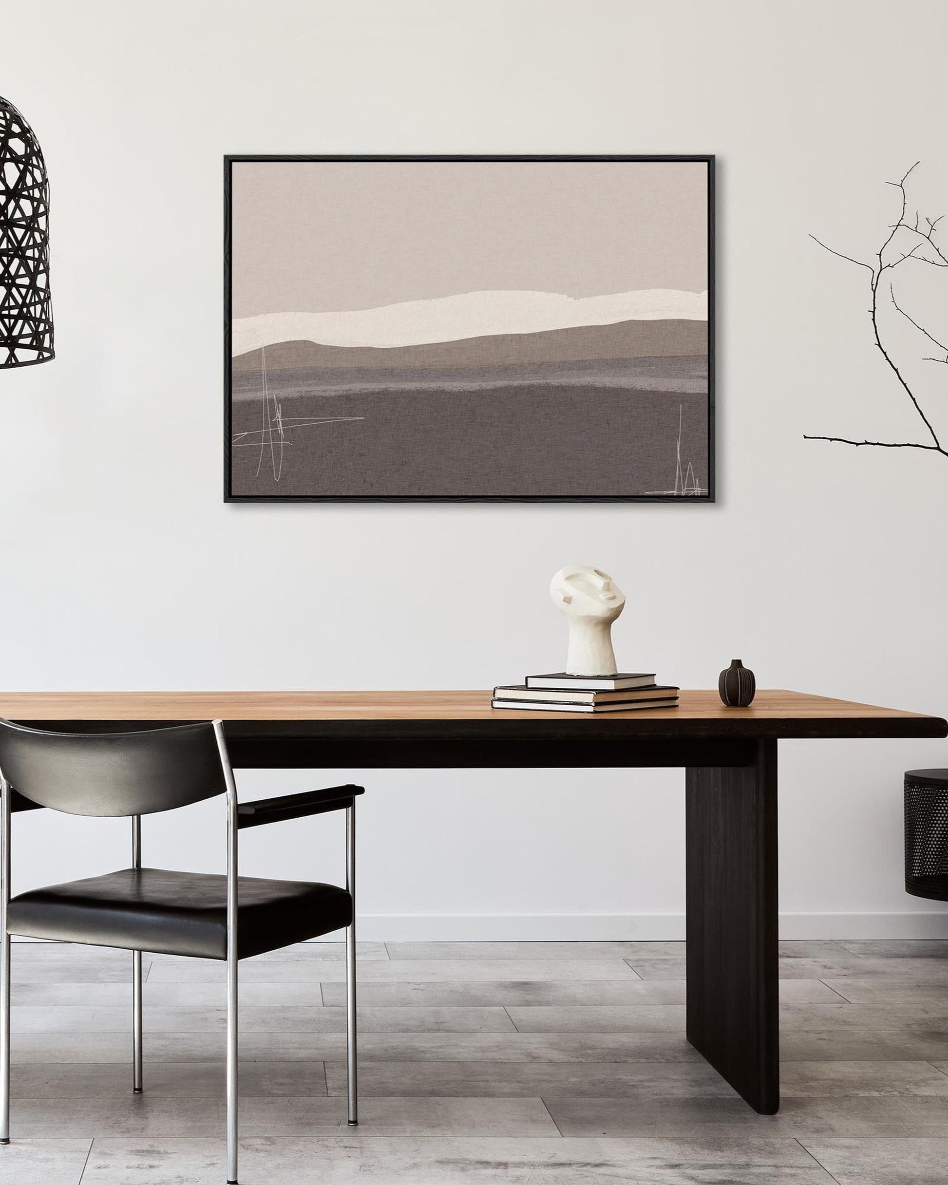 Dining room with a wooden table, black chairs, and abstract art on the wall.