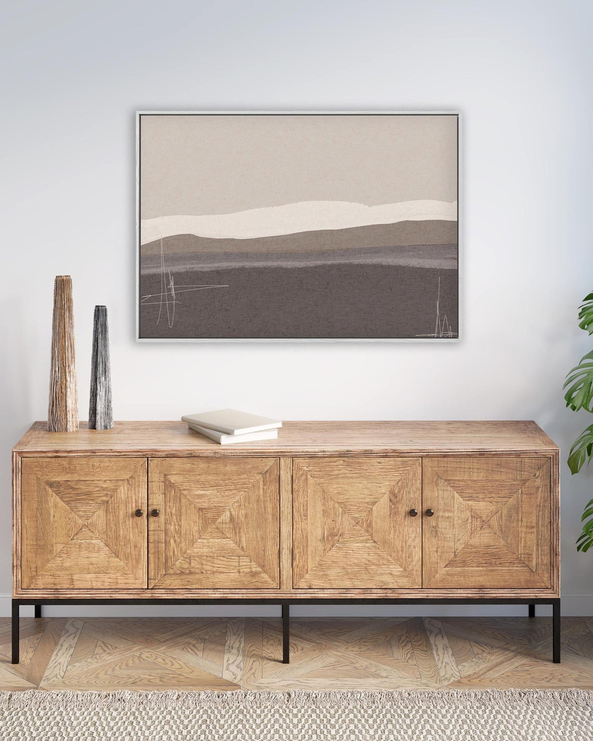 Wooden sideboard with decorative items and abstract art in a room.