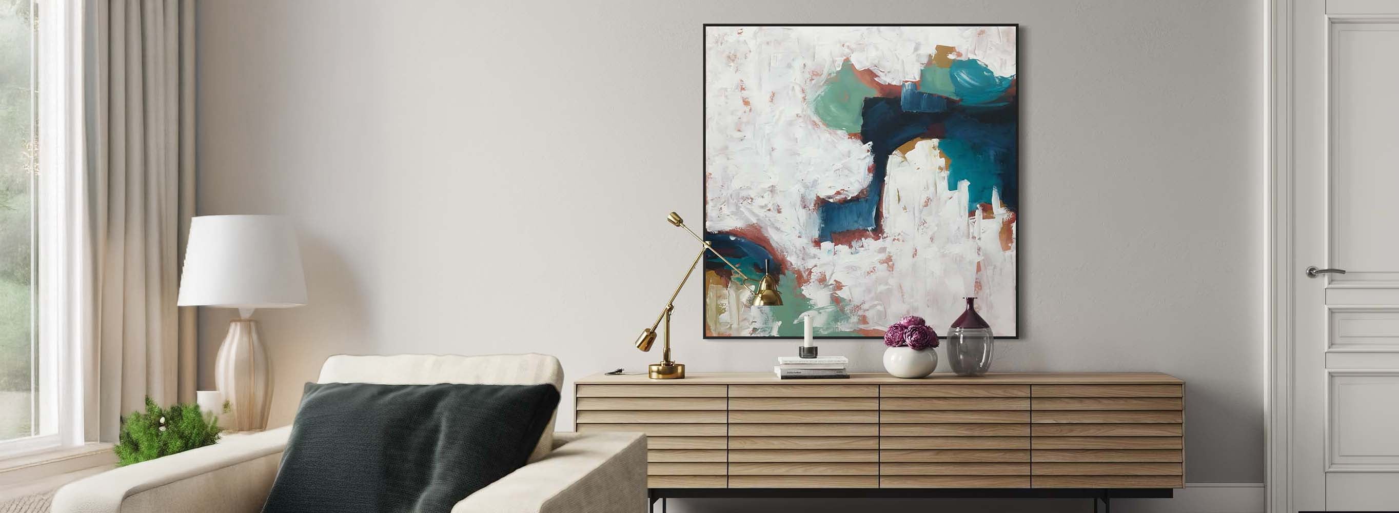 Modern living room with a abstract painting on the wall, lamp, and console table.