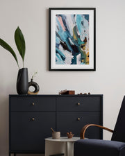 Modern interior with a black dresser, abstract art, and decorative items.