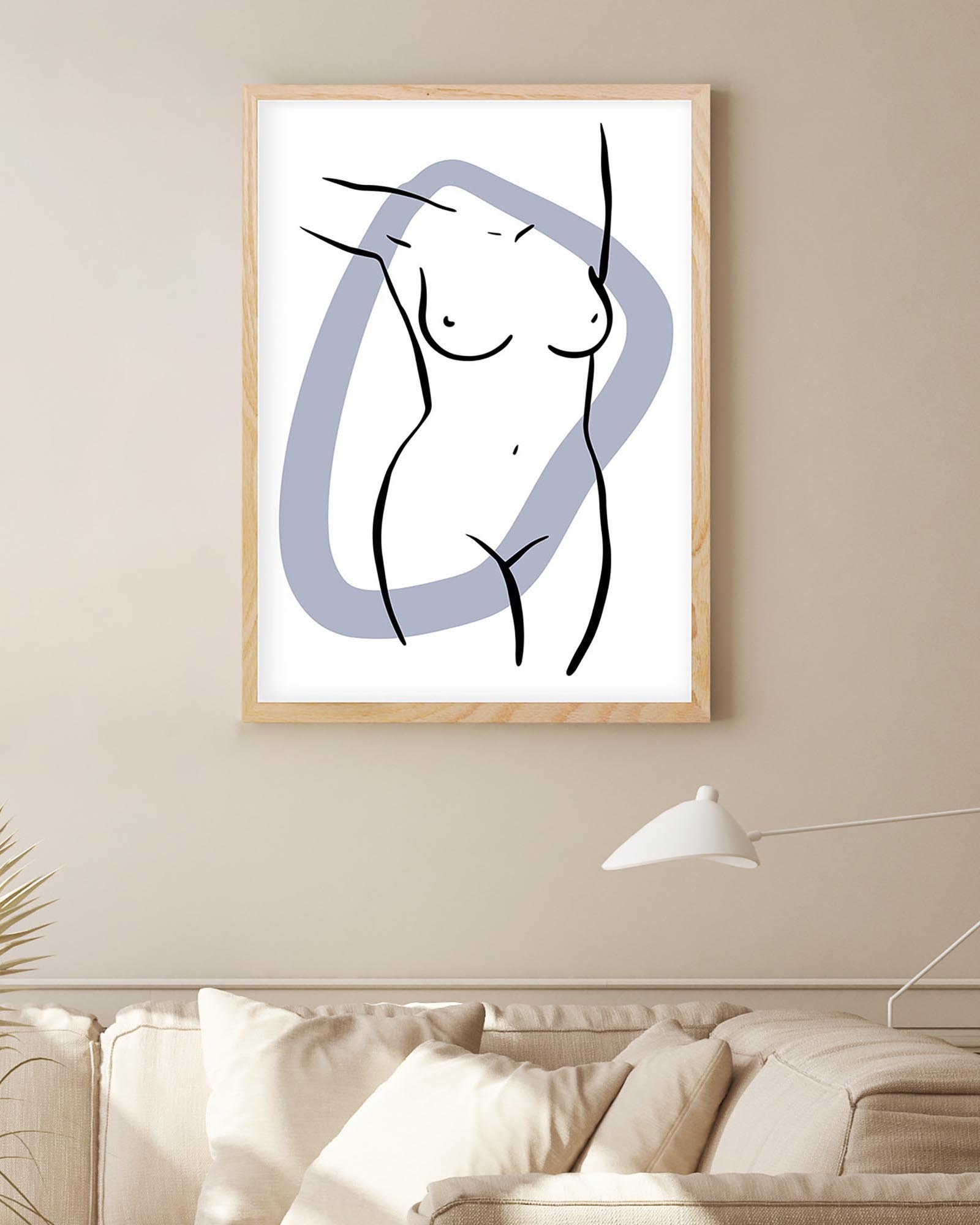 Framed abstract art of a nude figure on a wall above a sofa.