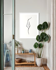 Modern interior with a plant, shelf, and abstract art on the wall.