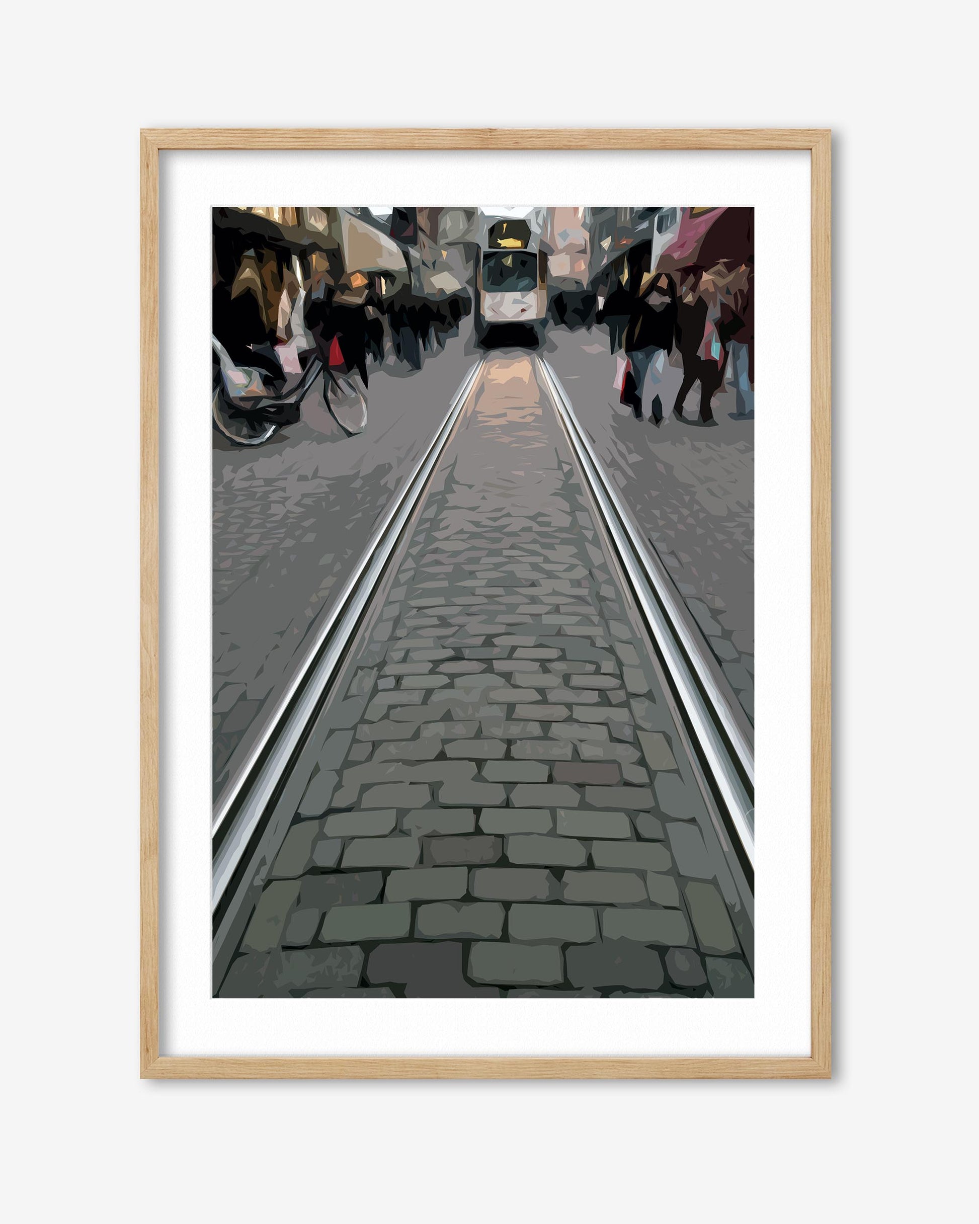 Framed photograph of a street scene with tram tracks and people walking.