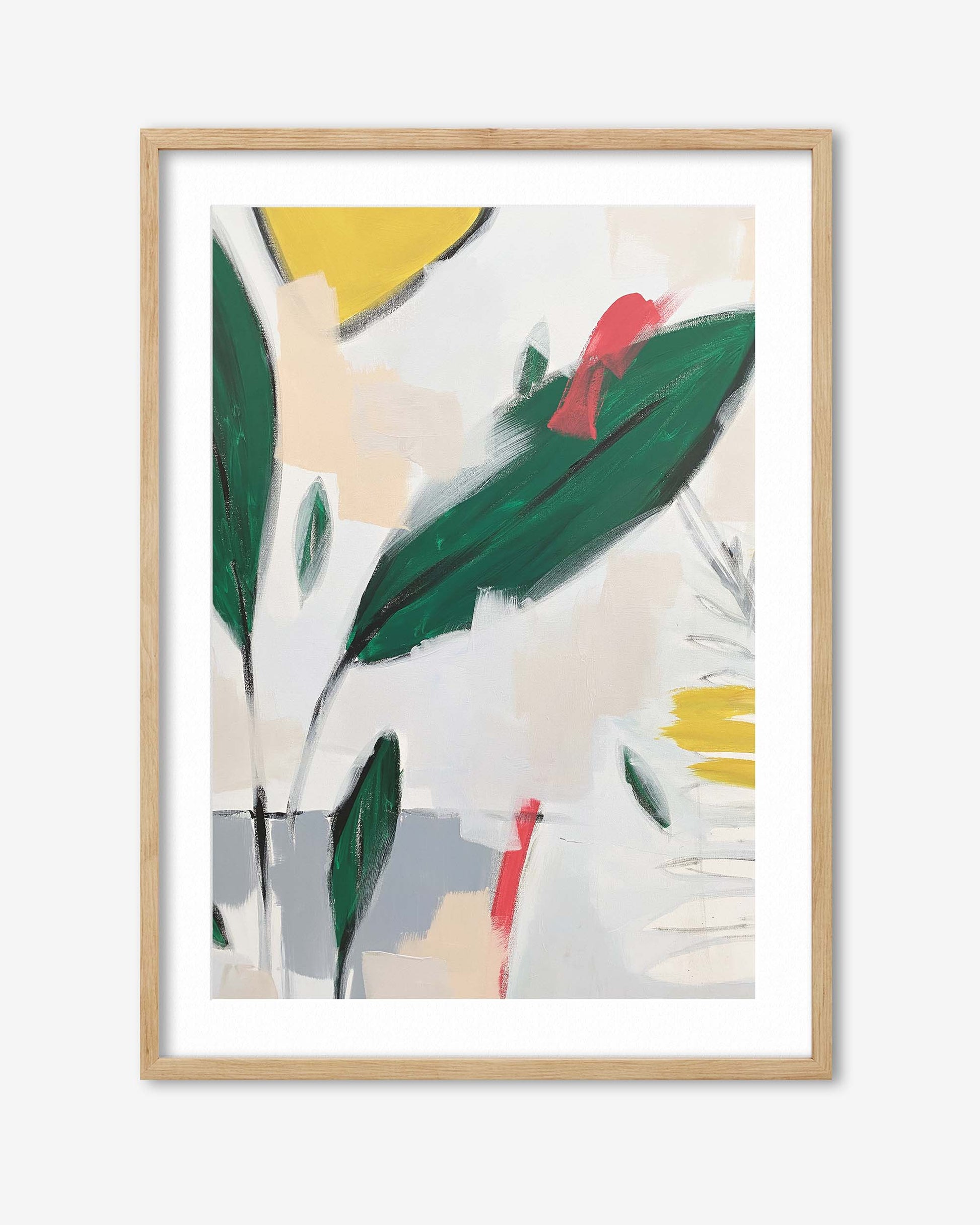Framed abstract art print with green leaves and colorful shapes on a white background