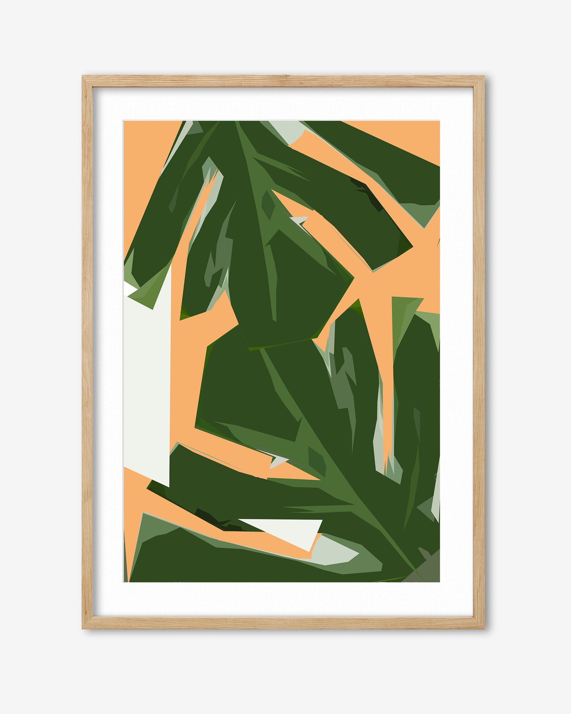 Framed artwork with green leaves on a peach background