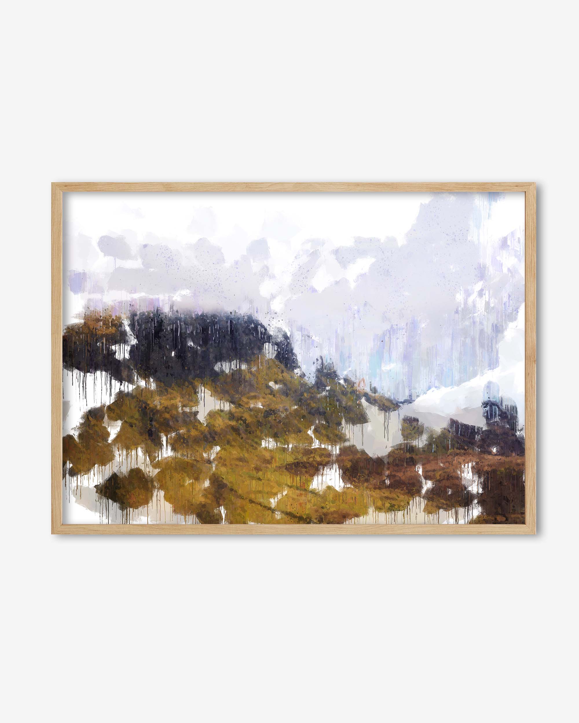 Framed artwork of a mountain landscape with blue sky and clouds.