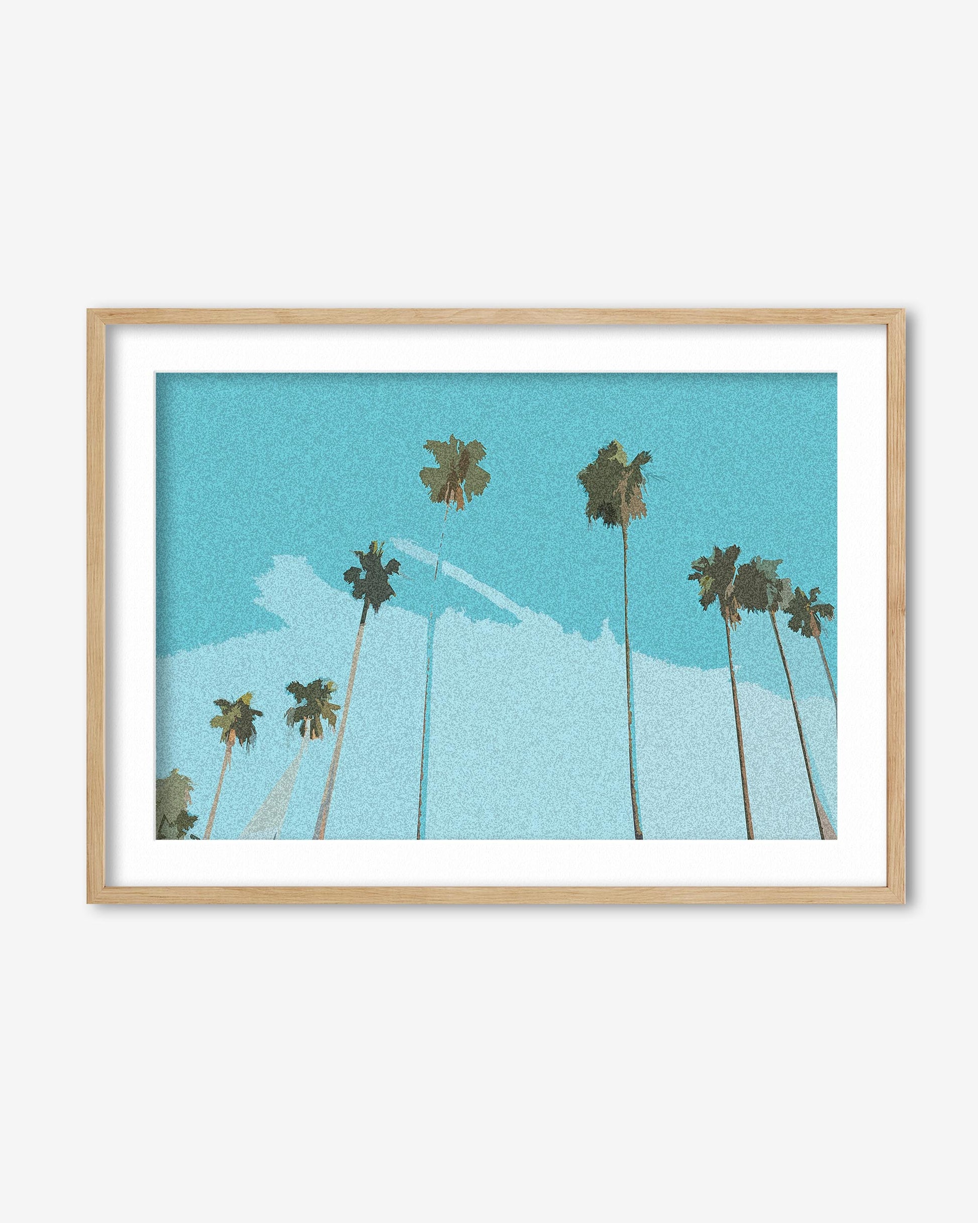 Framed artwork of palm trees against a blue sky with a white cloud.