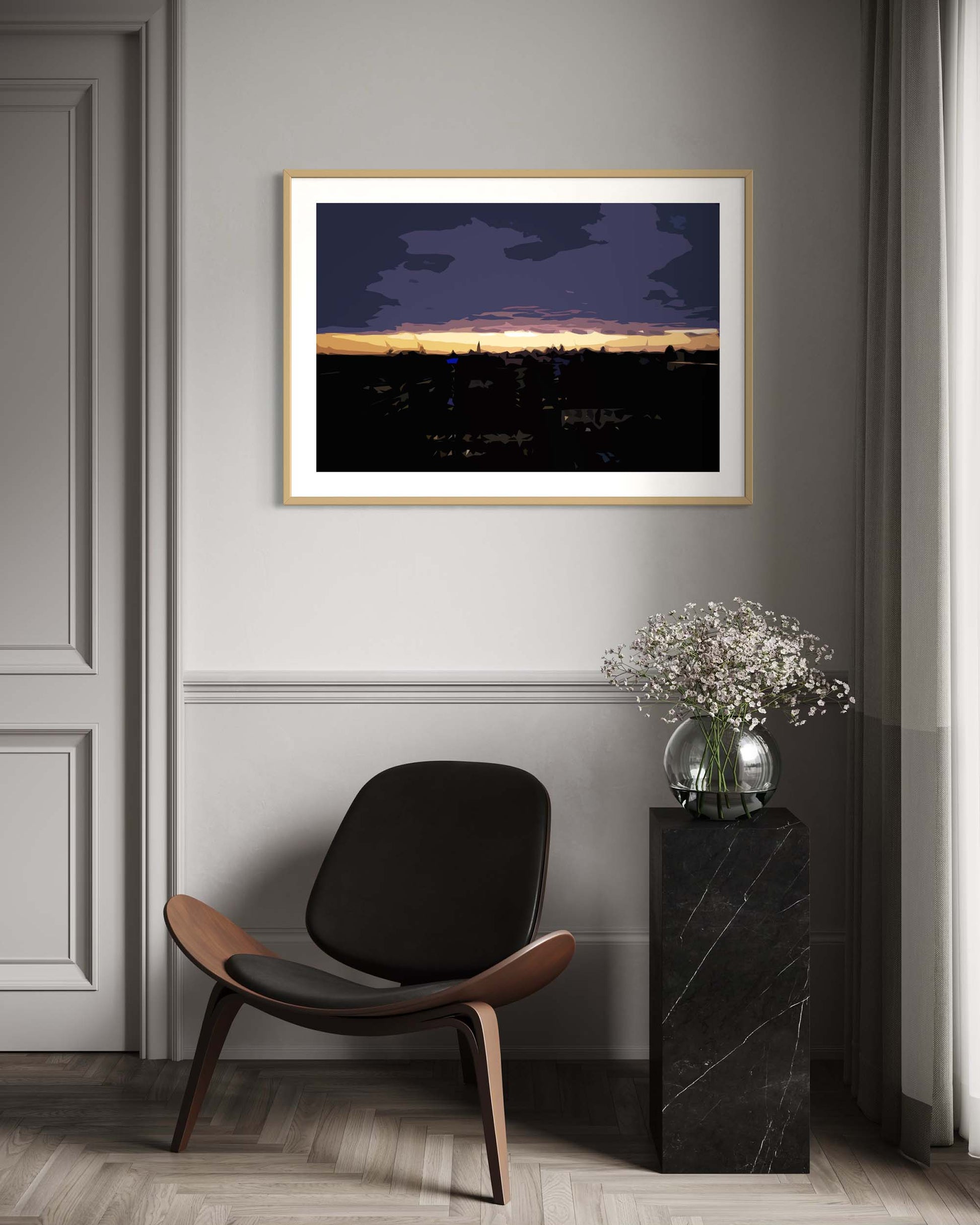 Framed artwork on a wall above a modern chair in a room with a vase of flowers on a side table.