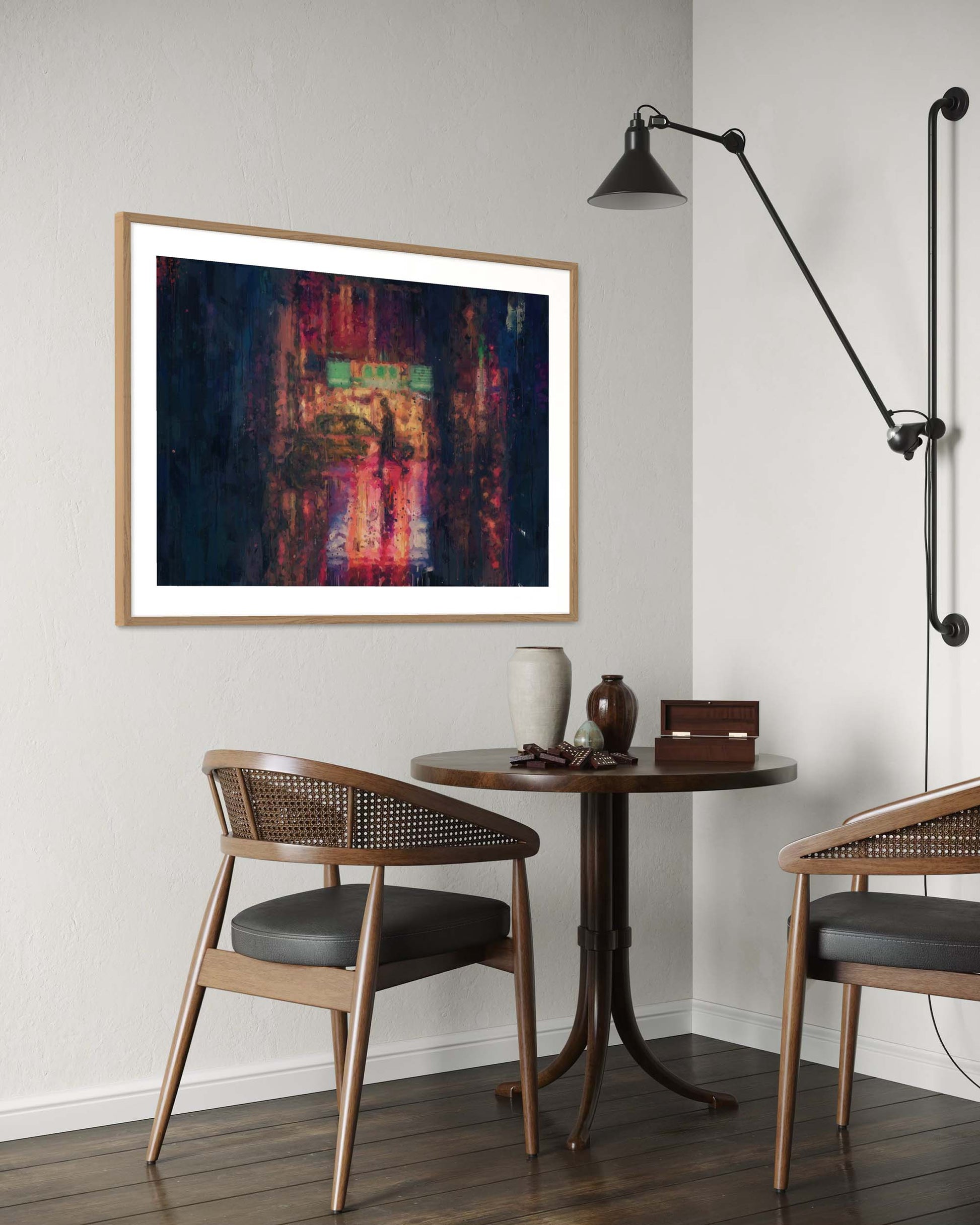 Modern interior with a small round table, chairs, and abstract art on the wall.
