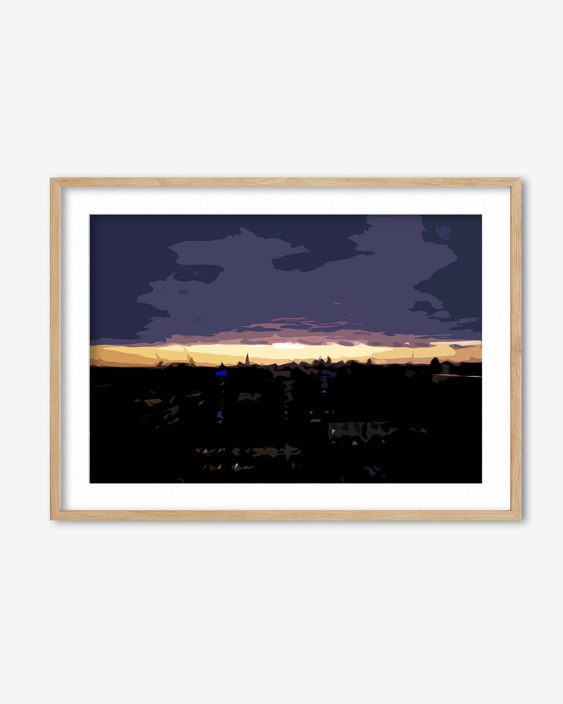 Framed artwork of a cityscape at sunset with a dark blue sky.