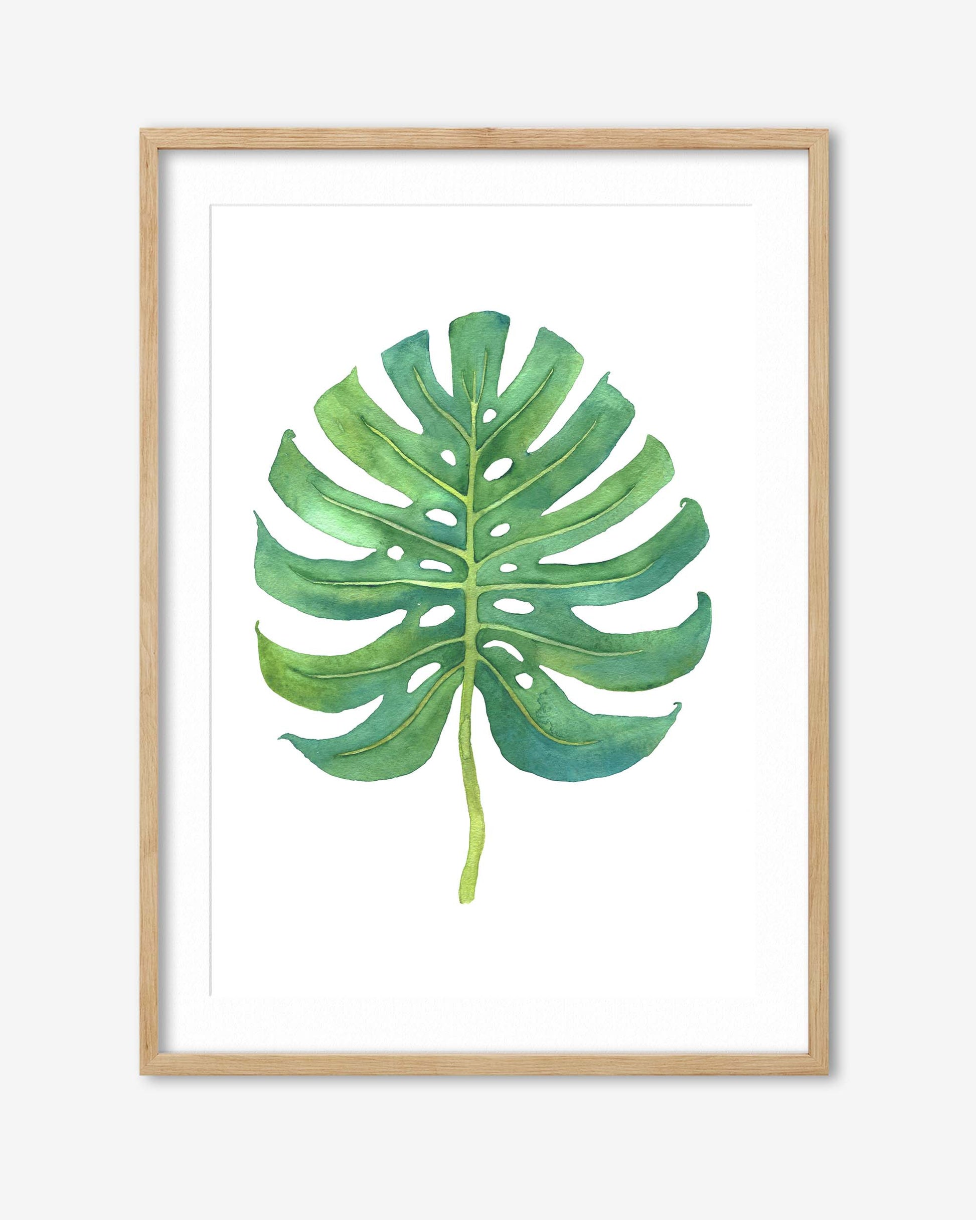 monstera leaf art print in an oak frame