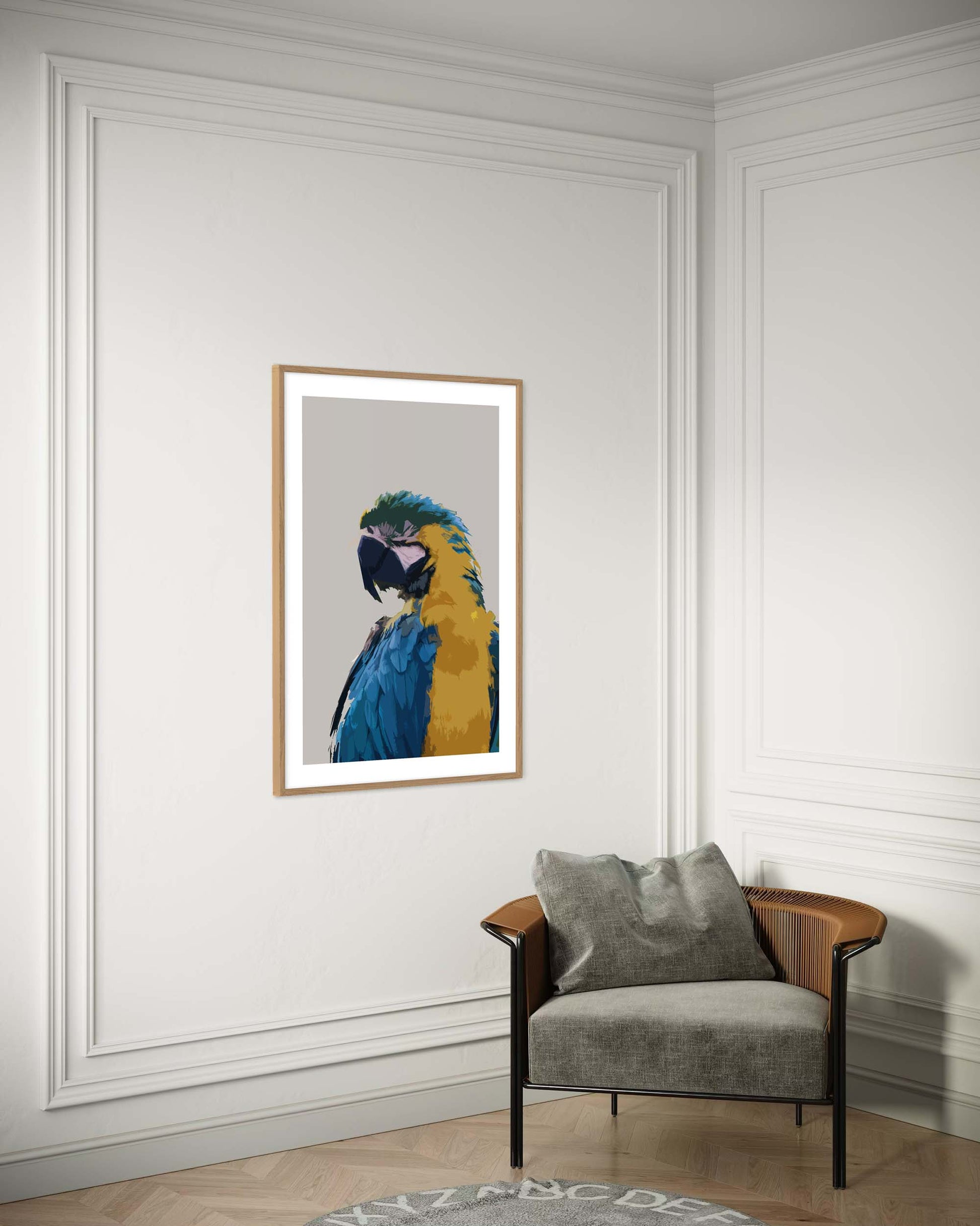 Framed artwork of a parrot on a wall above a gray armchair.