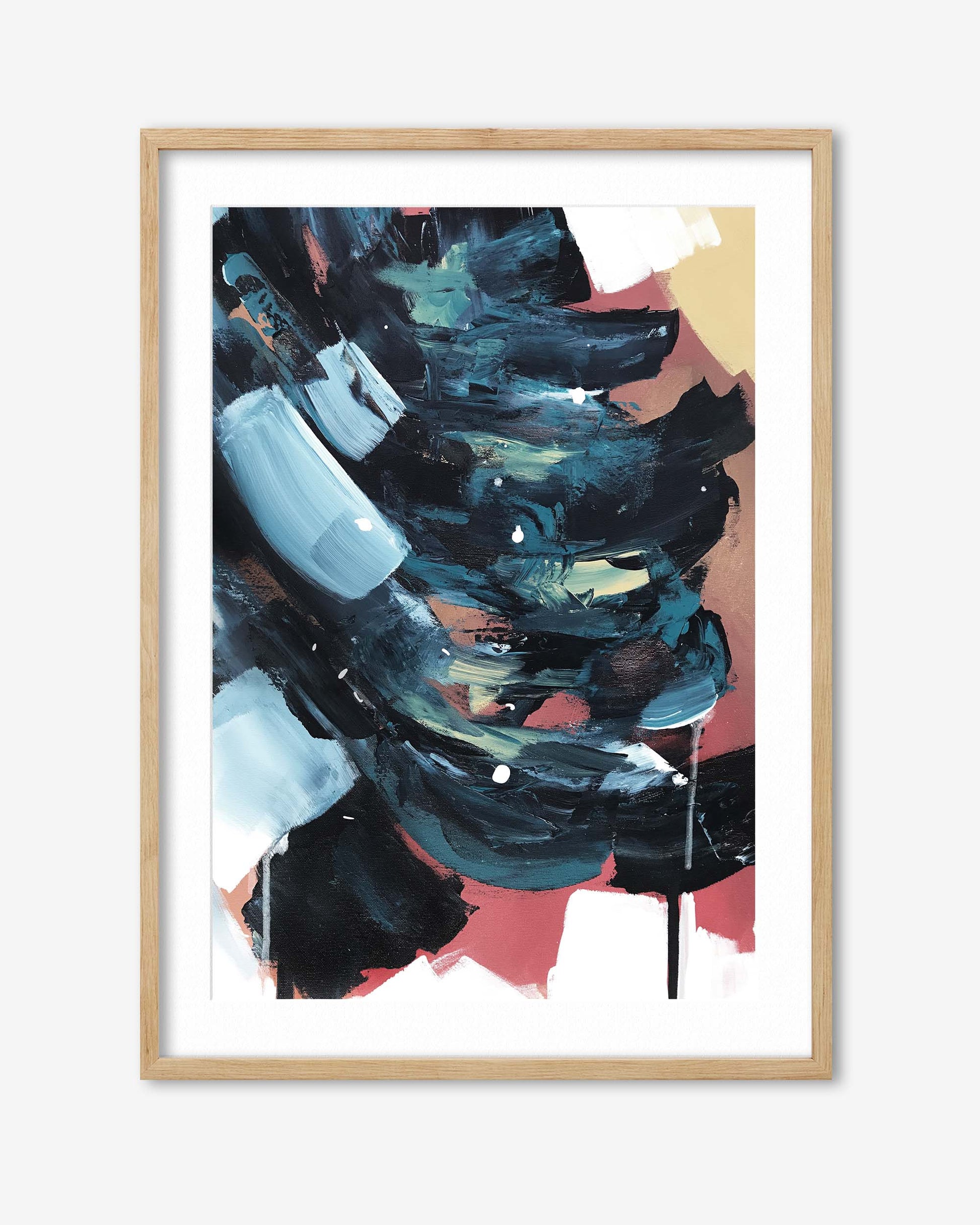 Abstract art print with bold colors in a wooden frame on a white background