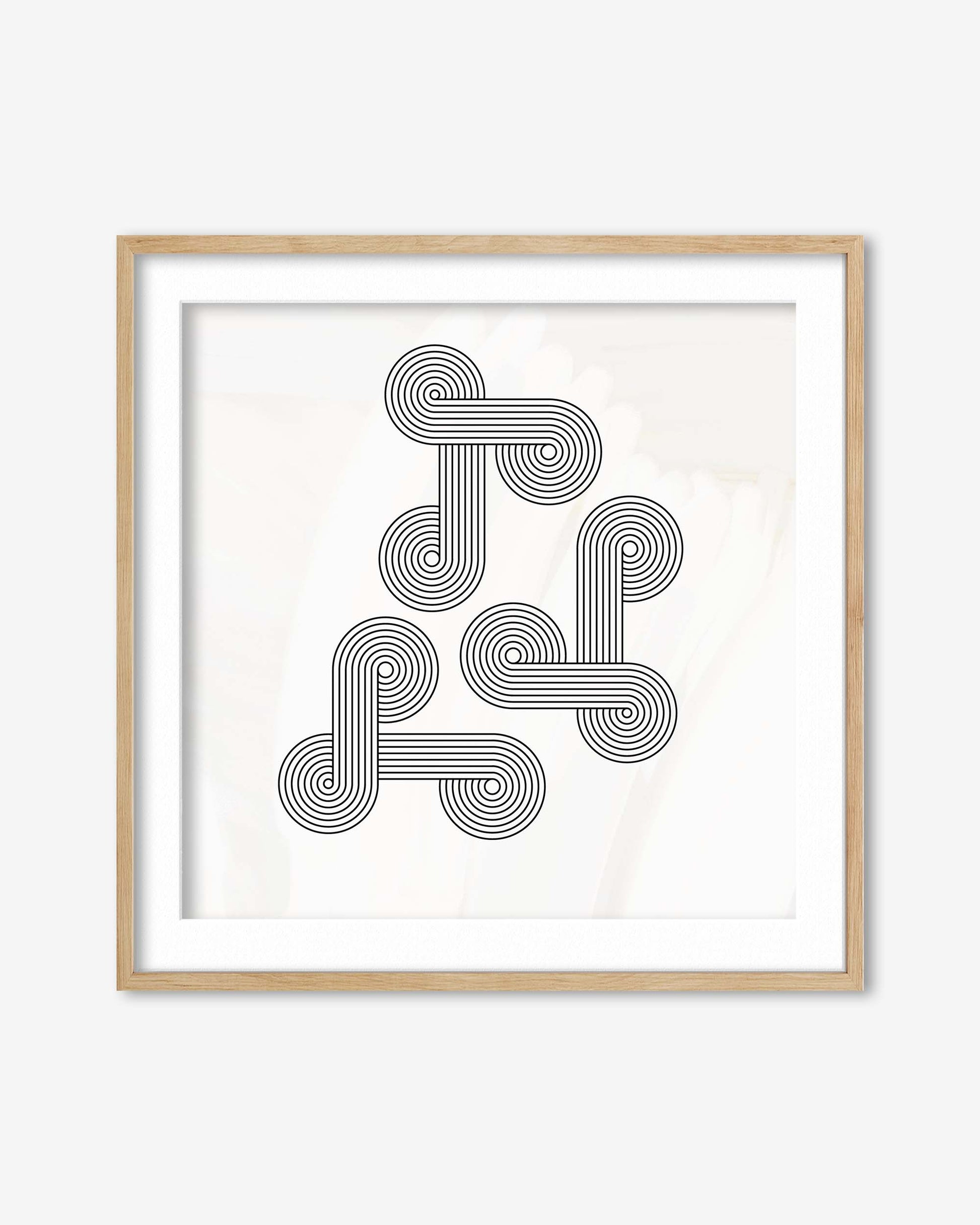 Framed abstract art print with interlocking circular patterns on a white background