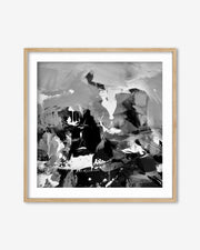 Abstract black and white artwork in a wooden frame on a white background