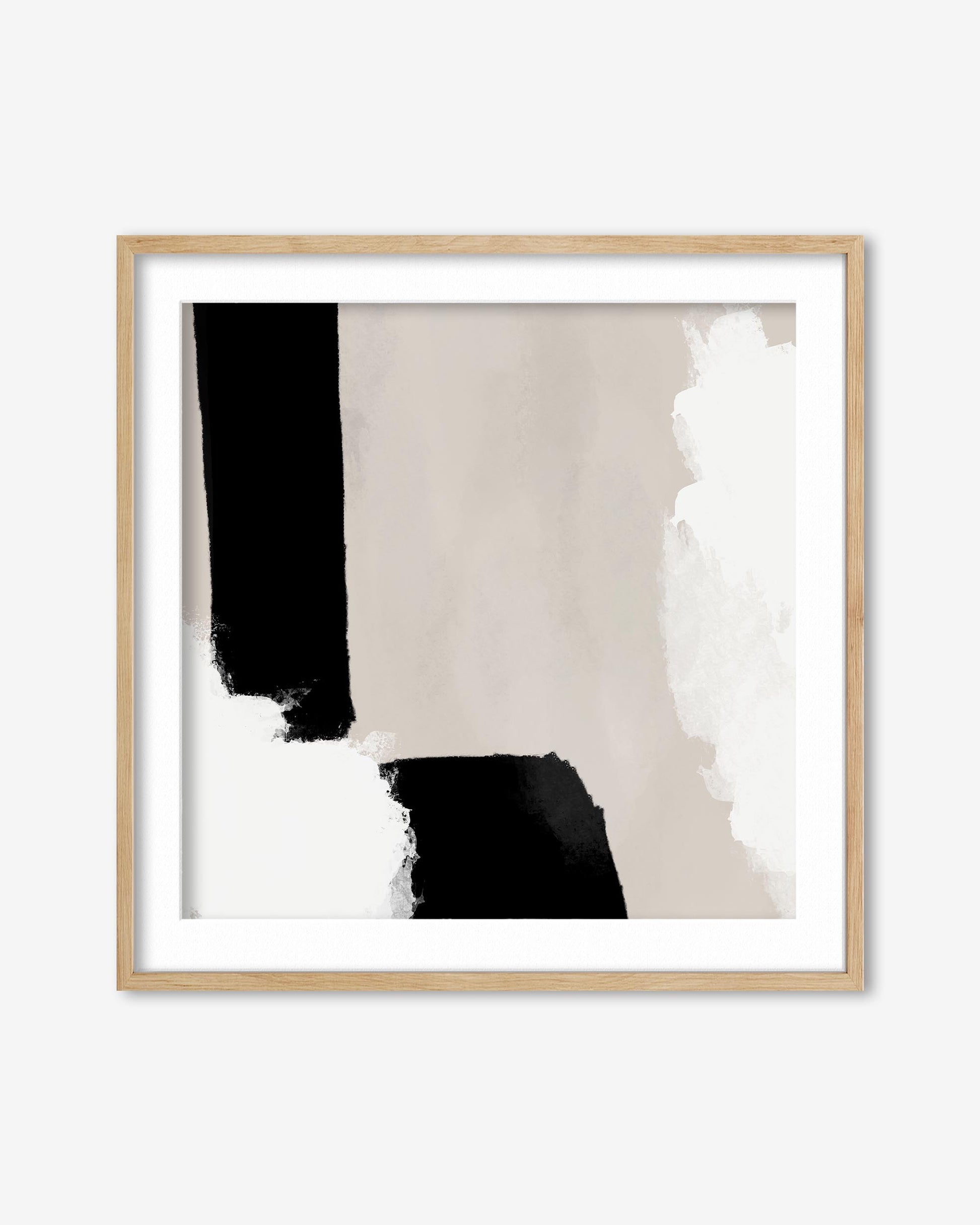 Abstract art print with black and white shapes in a wooden frame on a white background