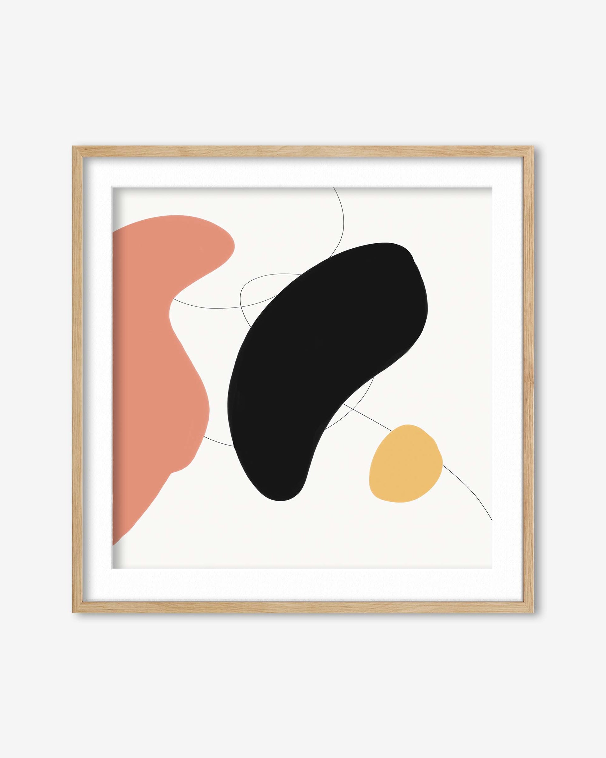 Abstract art print with pink, black, and yellow shapes in a wooden frame on a white background