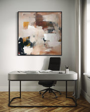 Modern office setup with a desk, chair, and abstract painting on a gray wall.