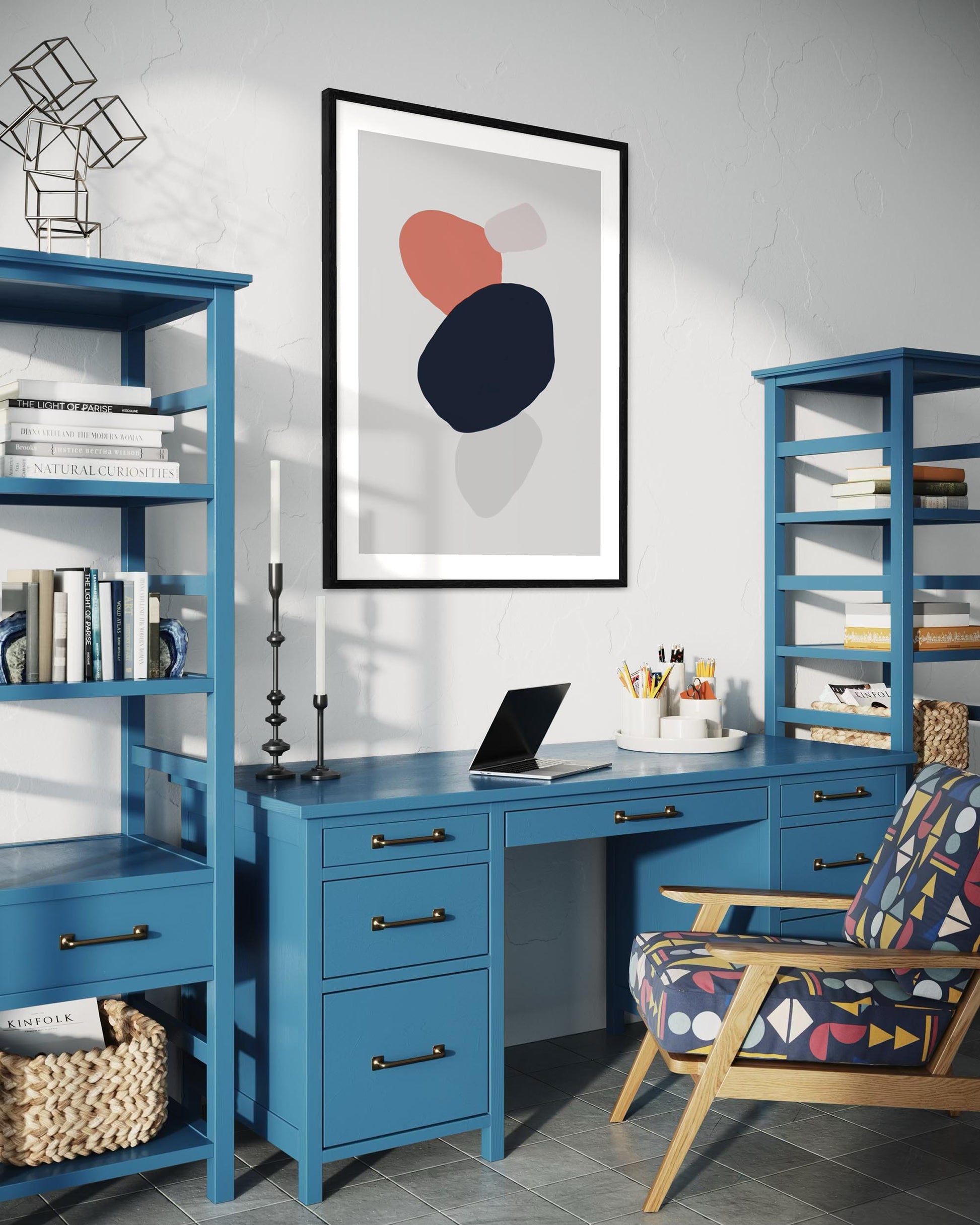 Modern home office with blue desk, shelves, and colorful chair.