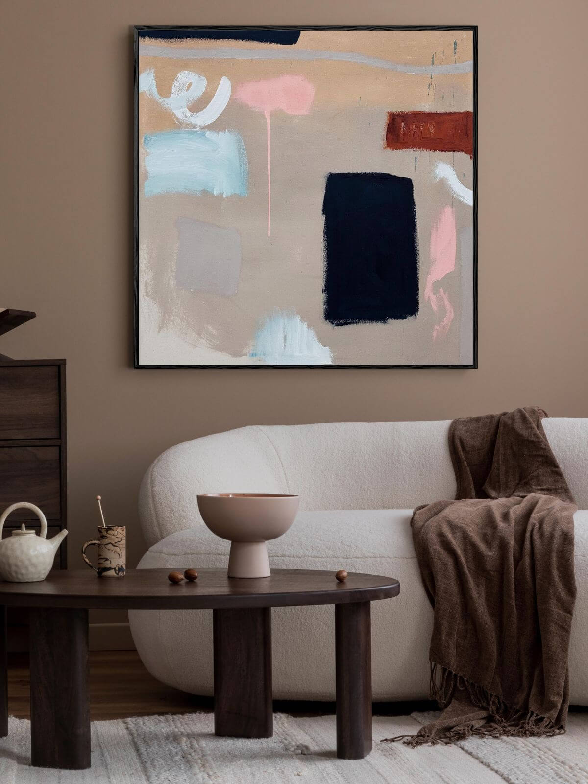abstract painting above sofa in living room