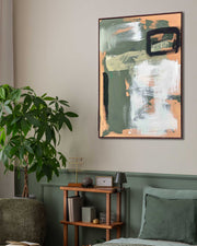 Abstract painting on a wall in a living room with a plant and bookshelf.