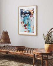 abstract art print in an oak frame on a wall