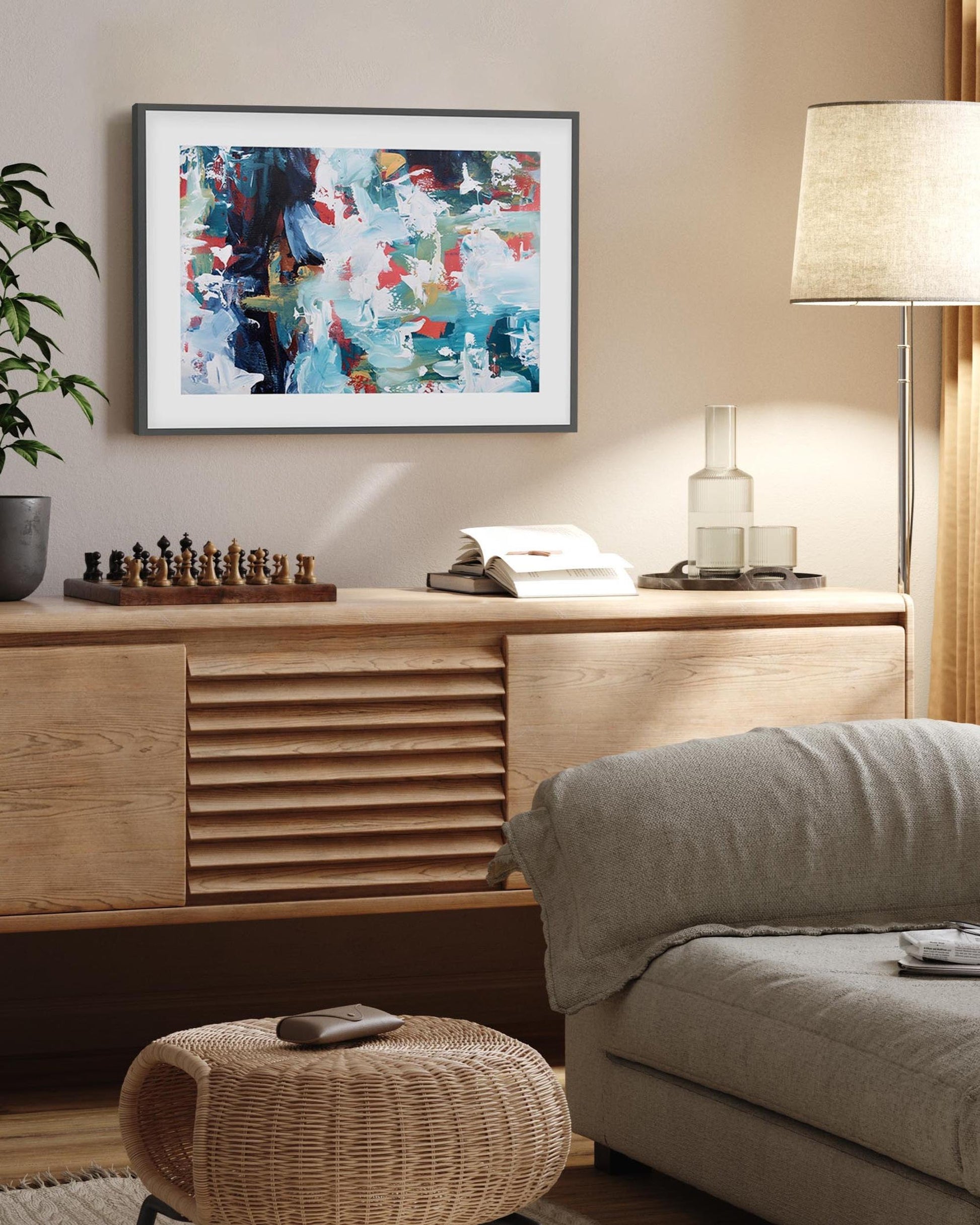 Living room with a wooden sideboard, sofa, and abstract art on the wall.