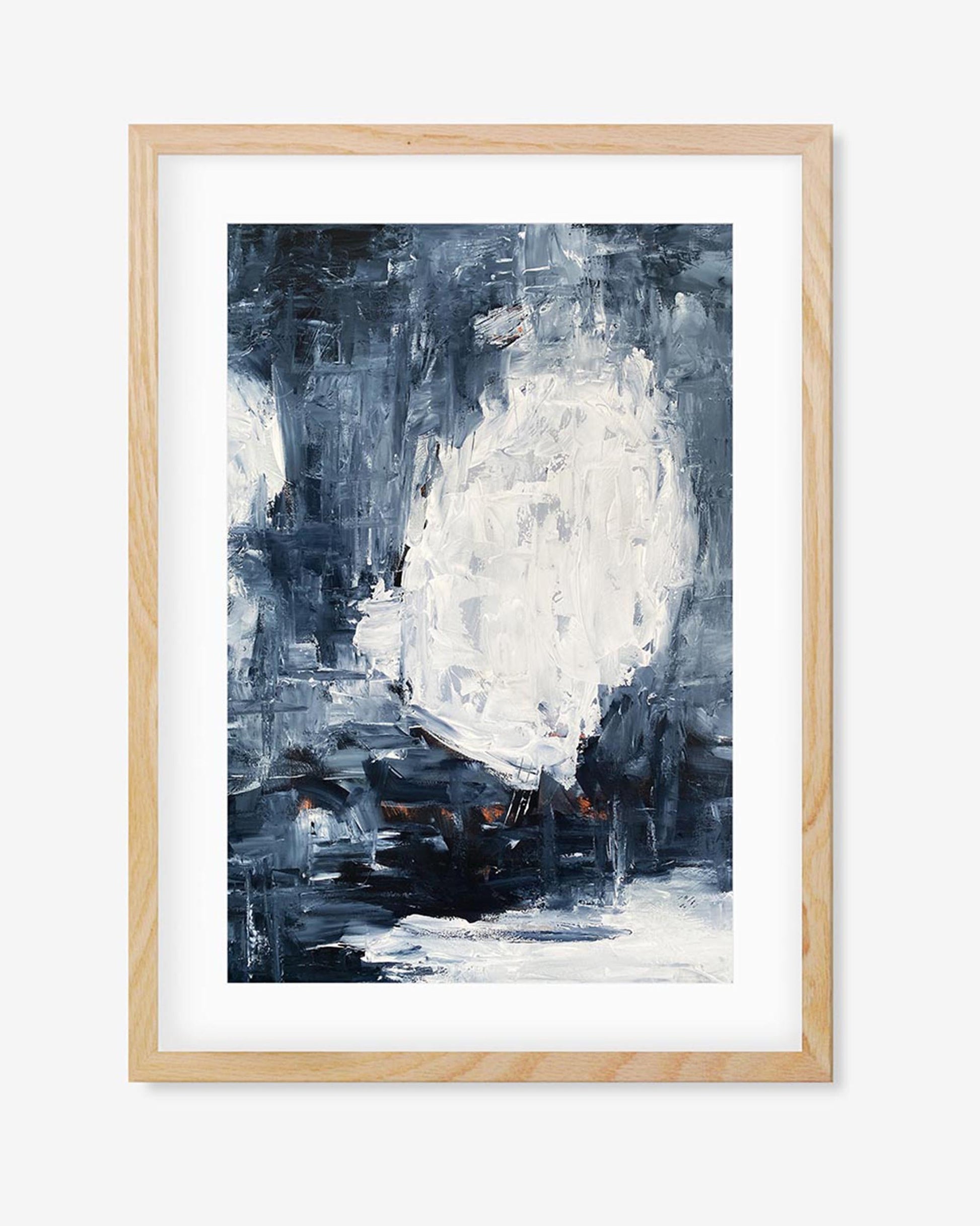 A framed abstract art print with dark blue and contrasting bright white colors, contained within a light wooden frame.