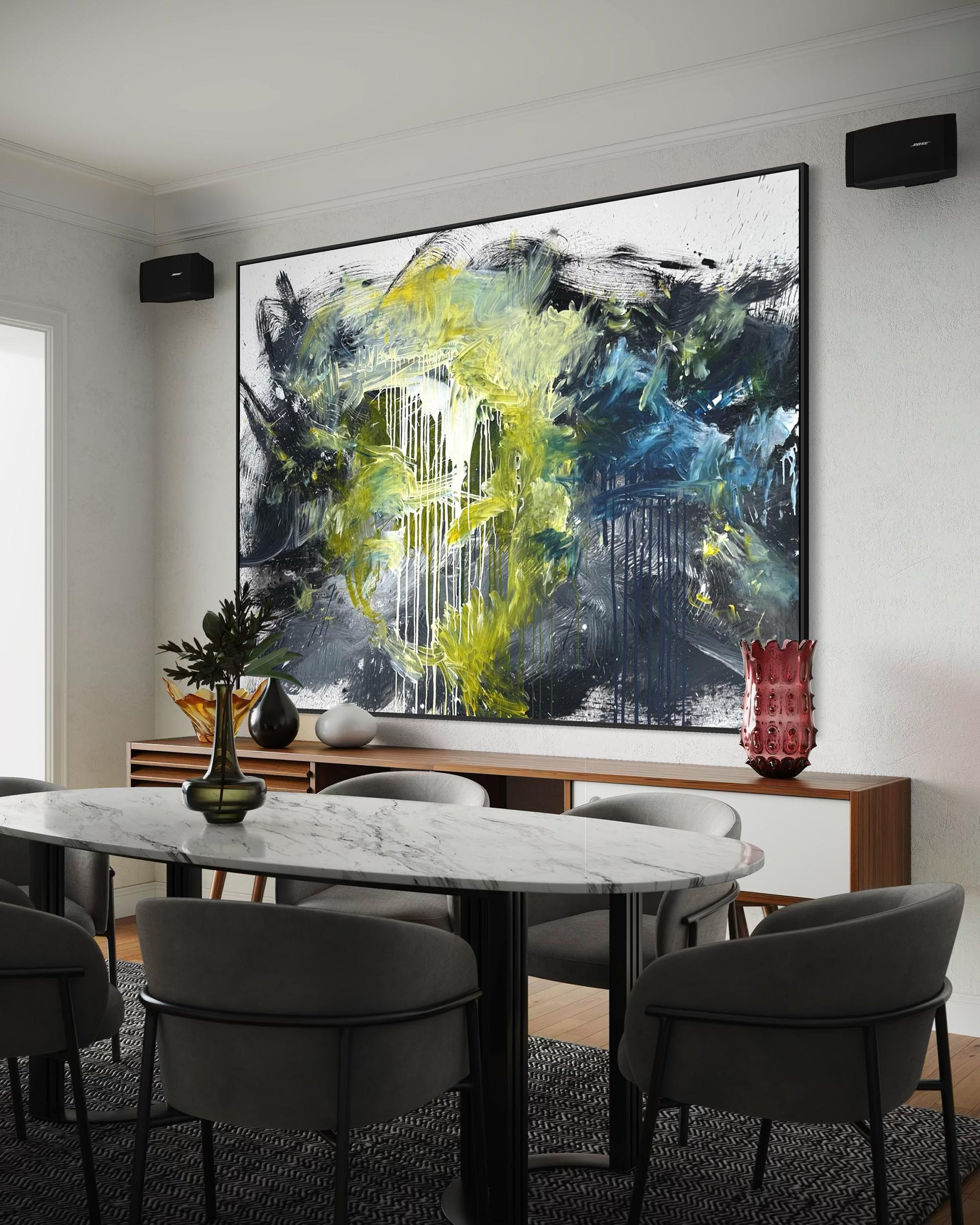 Dining room with a marble table and gray chairs, featuring an abstract painting on the wall.