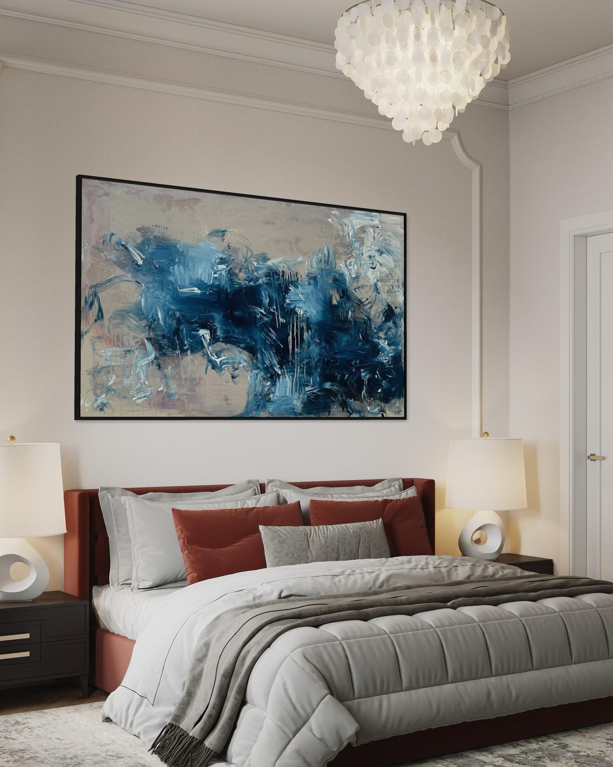 Modern bedroom with abstract blue artwork on the wall, bed with red and gray bedding, and chandelier.