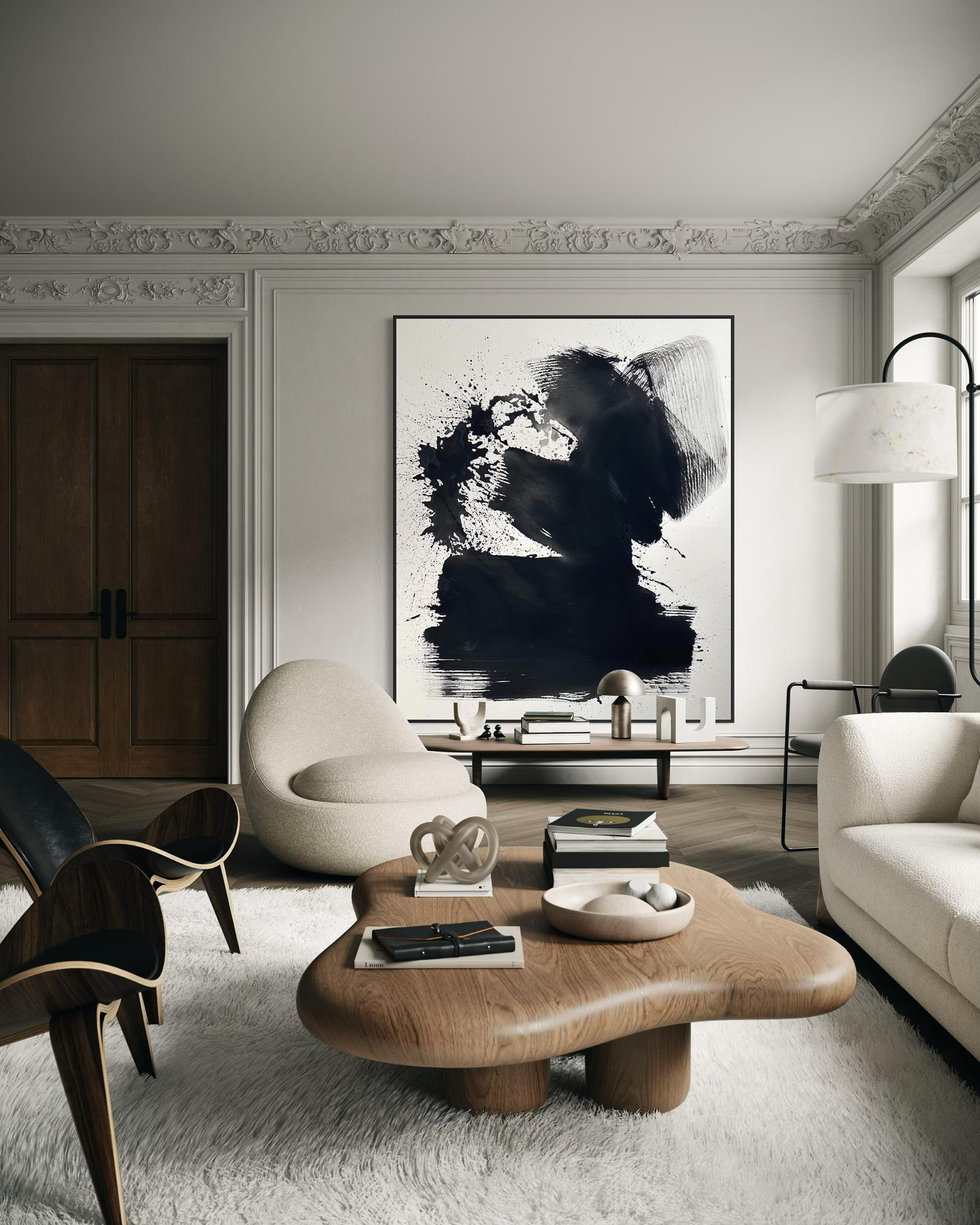 Modern living room with abstract art, wooden coffee table, and white sofa.