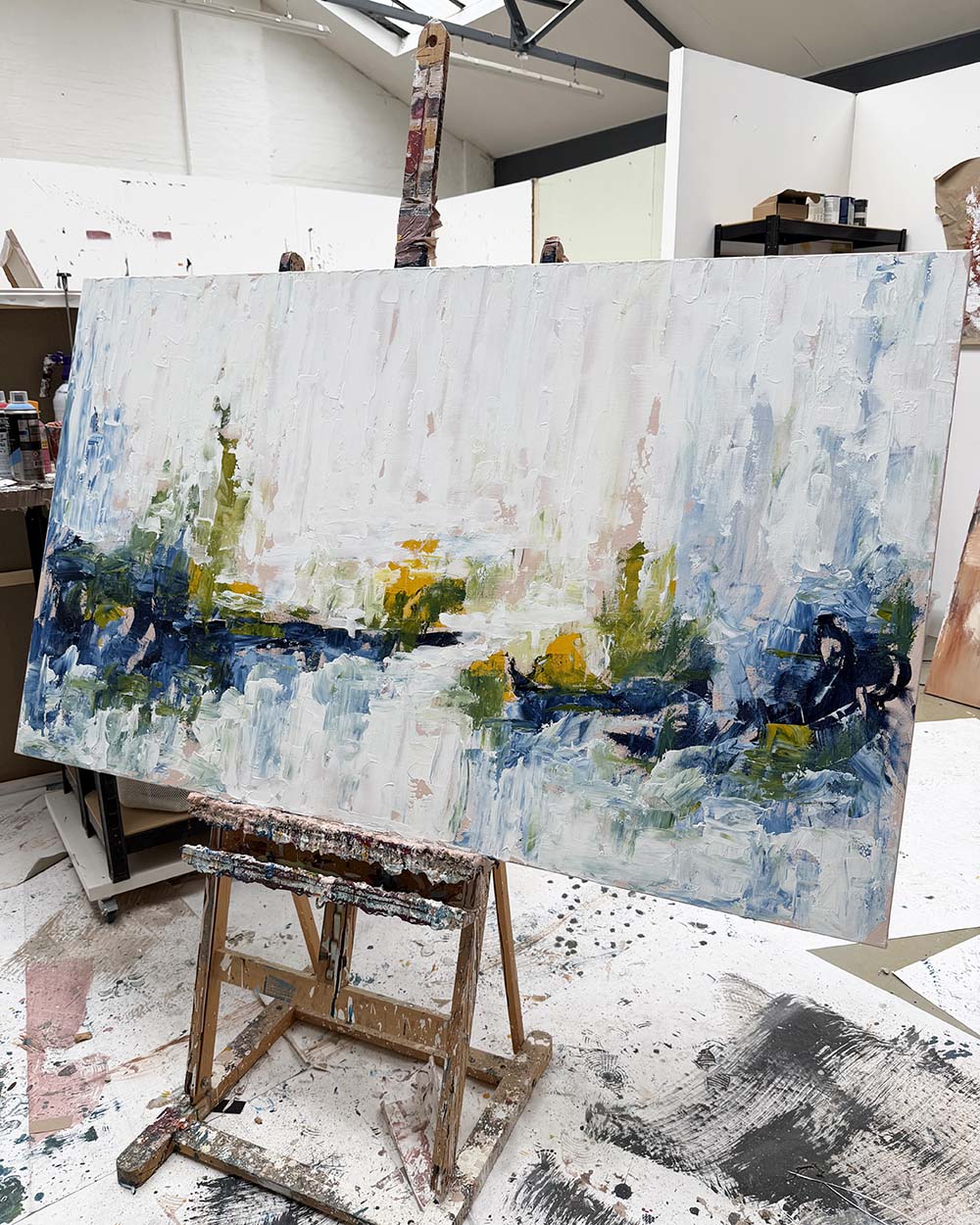 Abstract painting on an easel in a studio setting