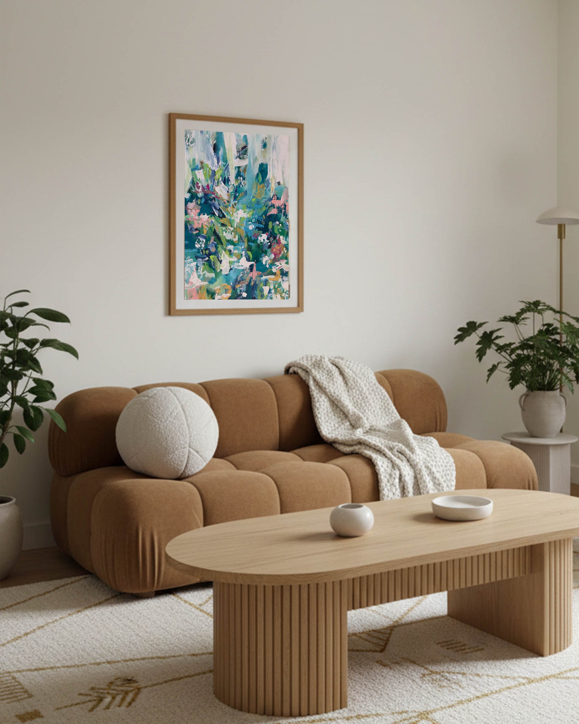 large modern scandinavian living room in apartment with modern colourful abstract wall art framed above the sofa, featuring oak coffee table