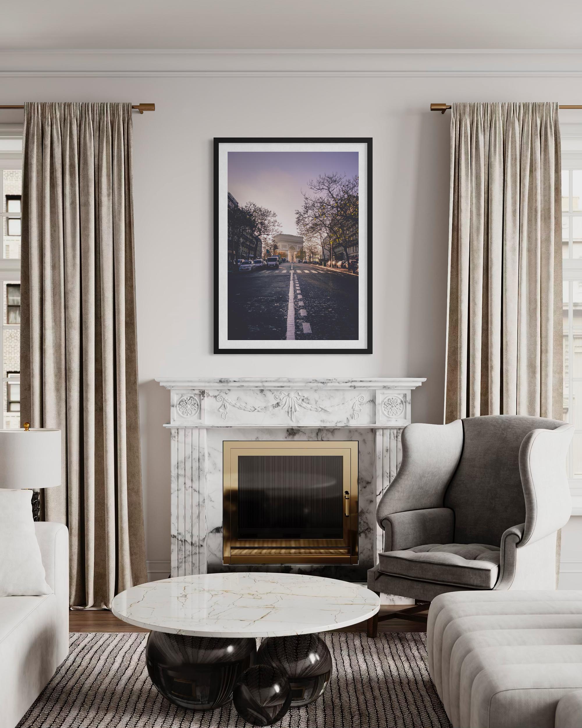 Living room with marble fireplace, gray armchair, and large windows.