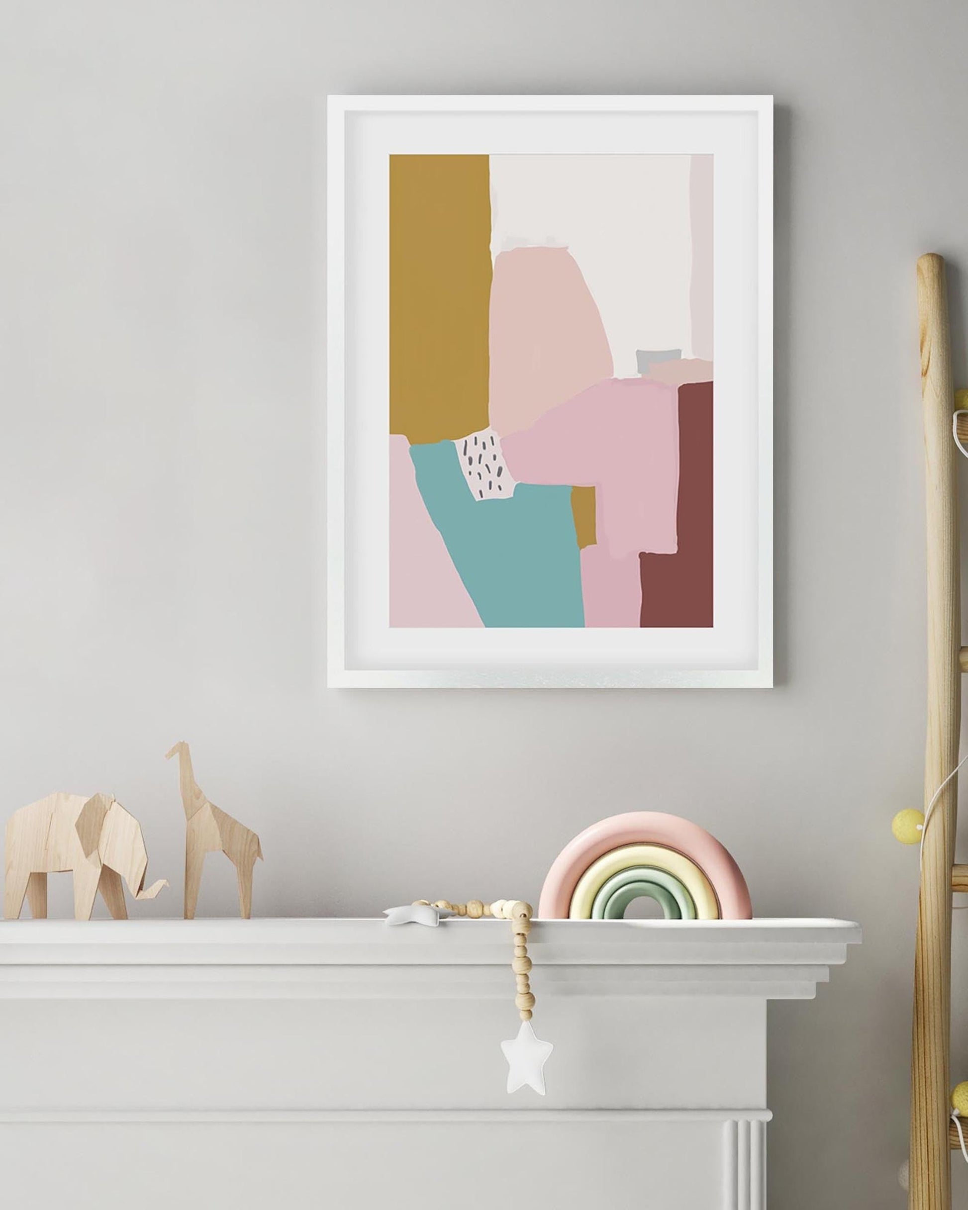 Framed abstract art print on a wall above a fireplace with decorative items.