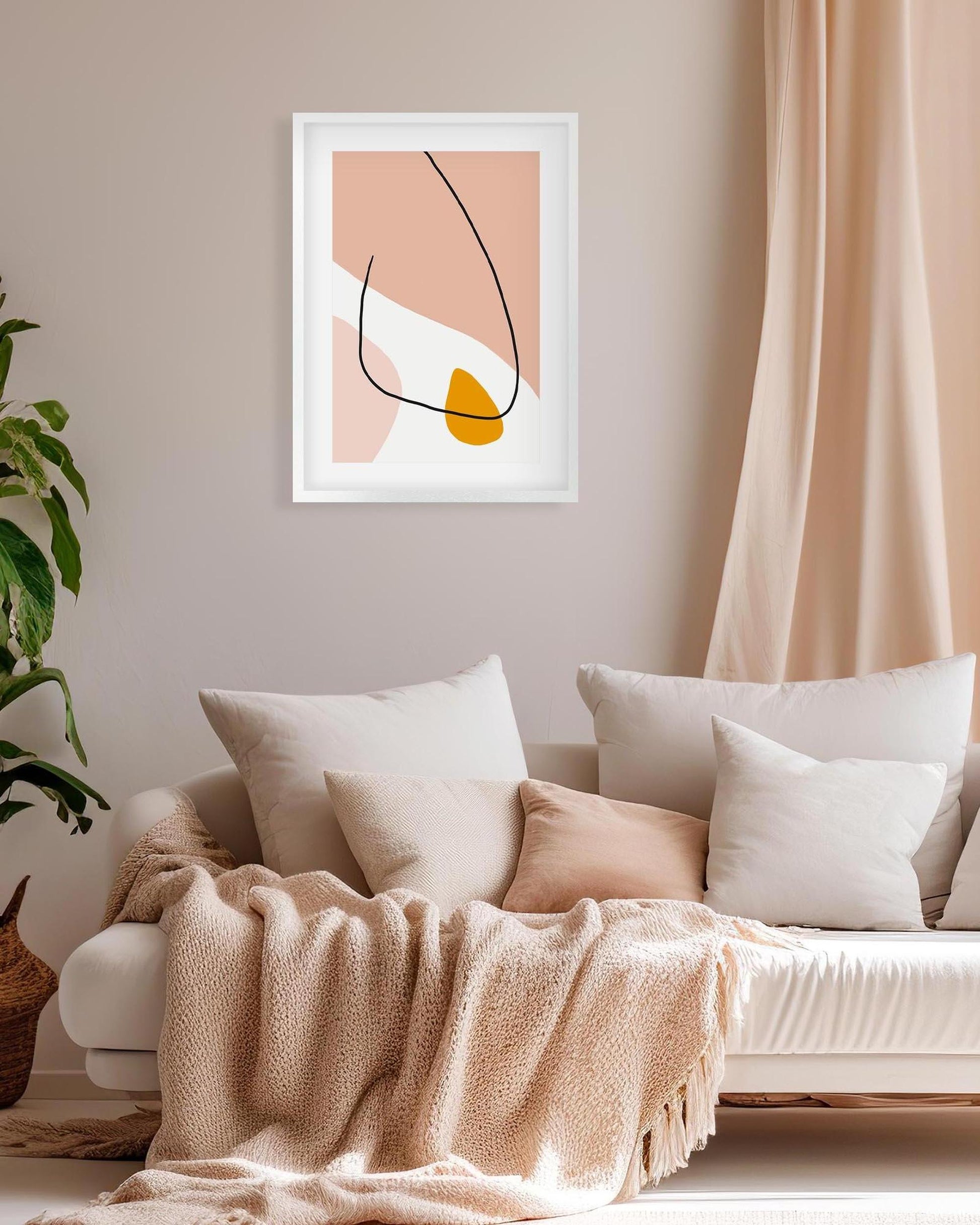 Living room with a couch, abstract art on the wall, and a plant.