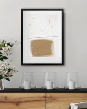 Abstract art piece on a wall above a wooden console table with decorative items.