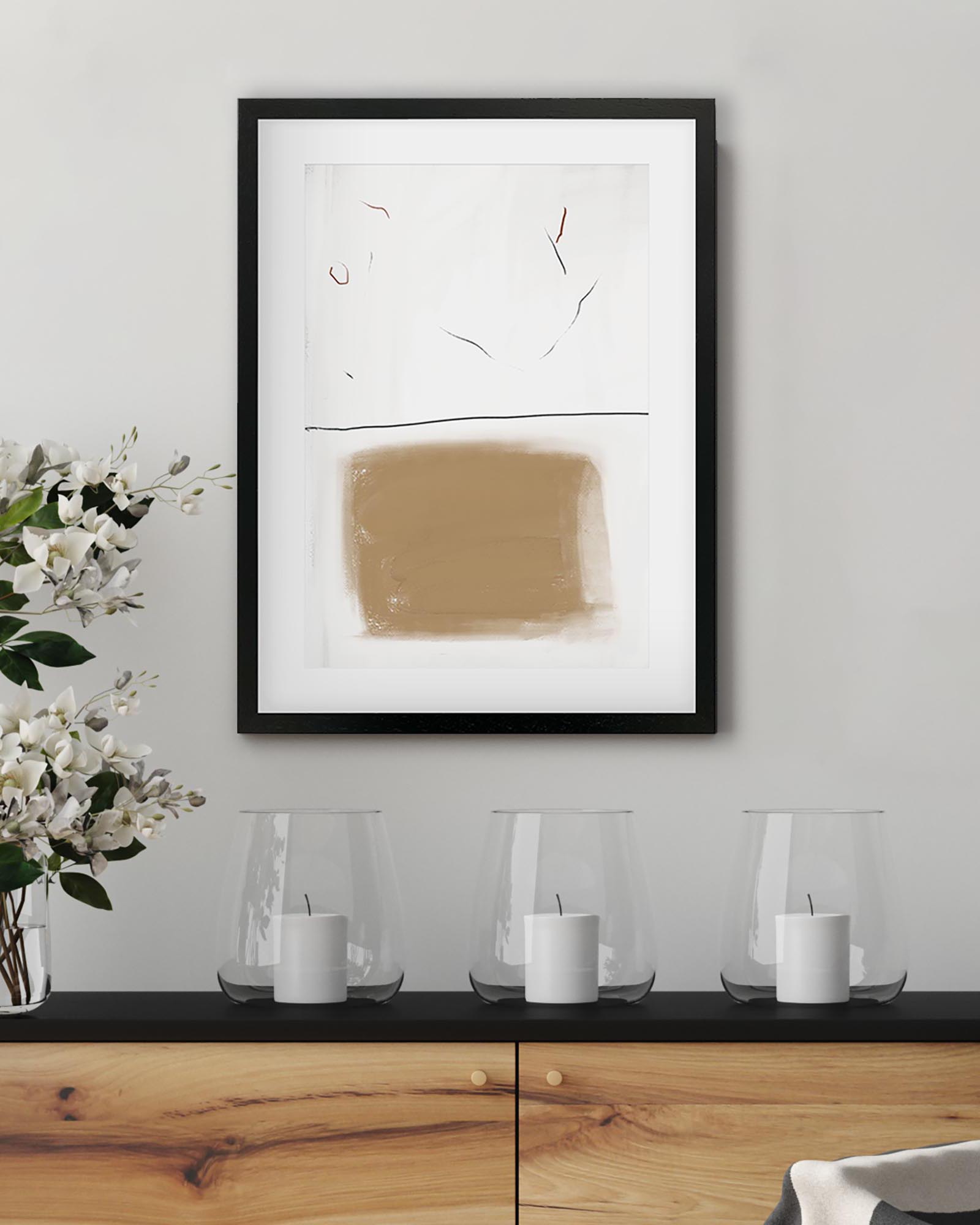 Abstract art piece on a wall above a wooden console table with decorative items.