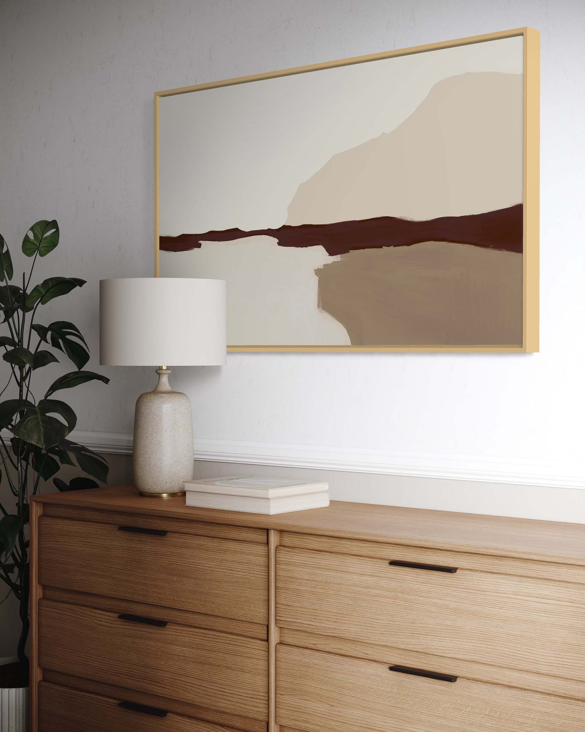 Wooden dresser with a lamp and abstract painting on the wall