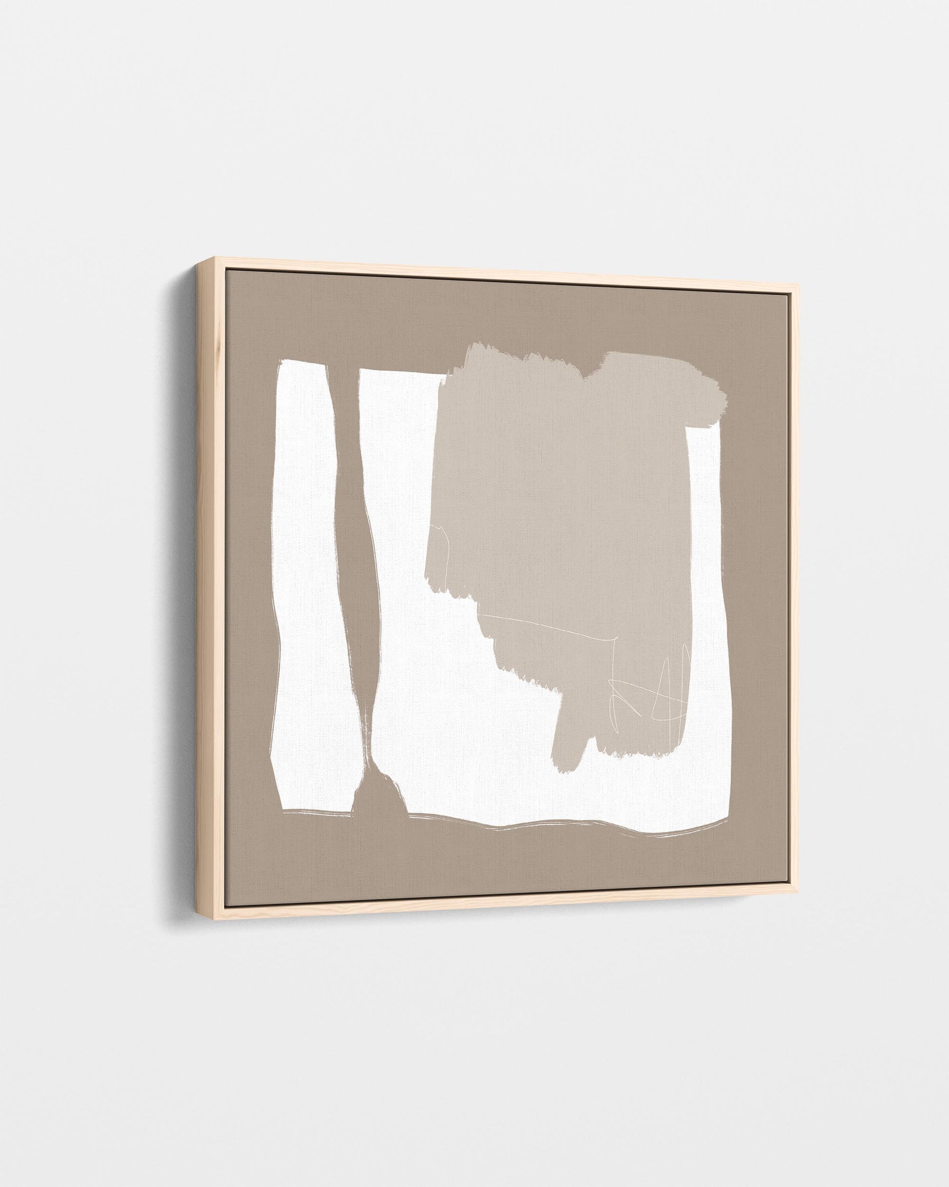 Abstract art piece with a gold frame on a white wall