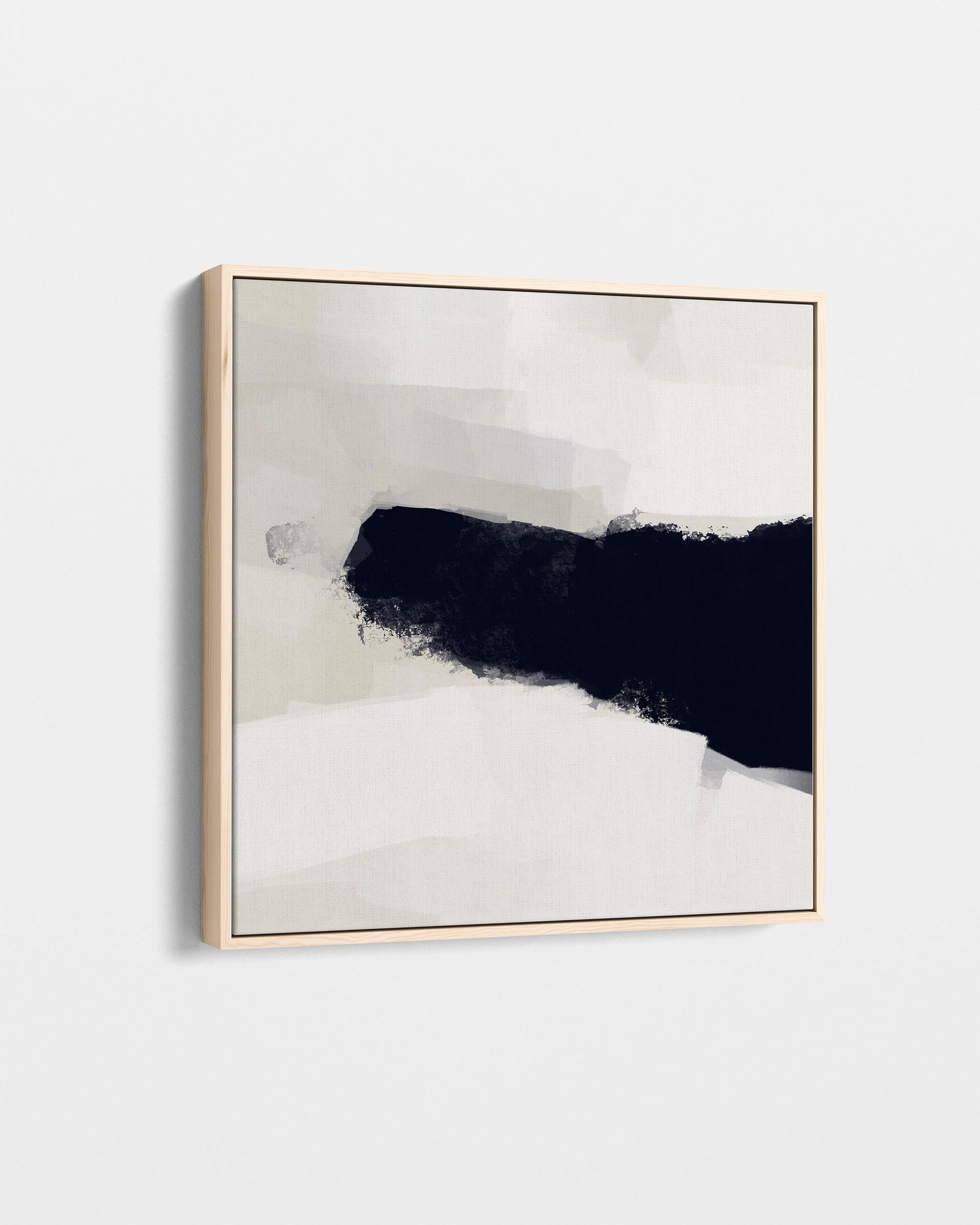 Abstract art piece with black and white brush strokes in a gold frame on a light gray background