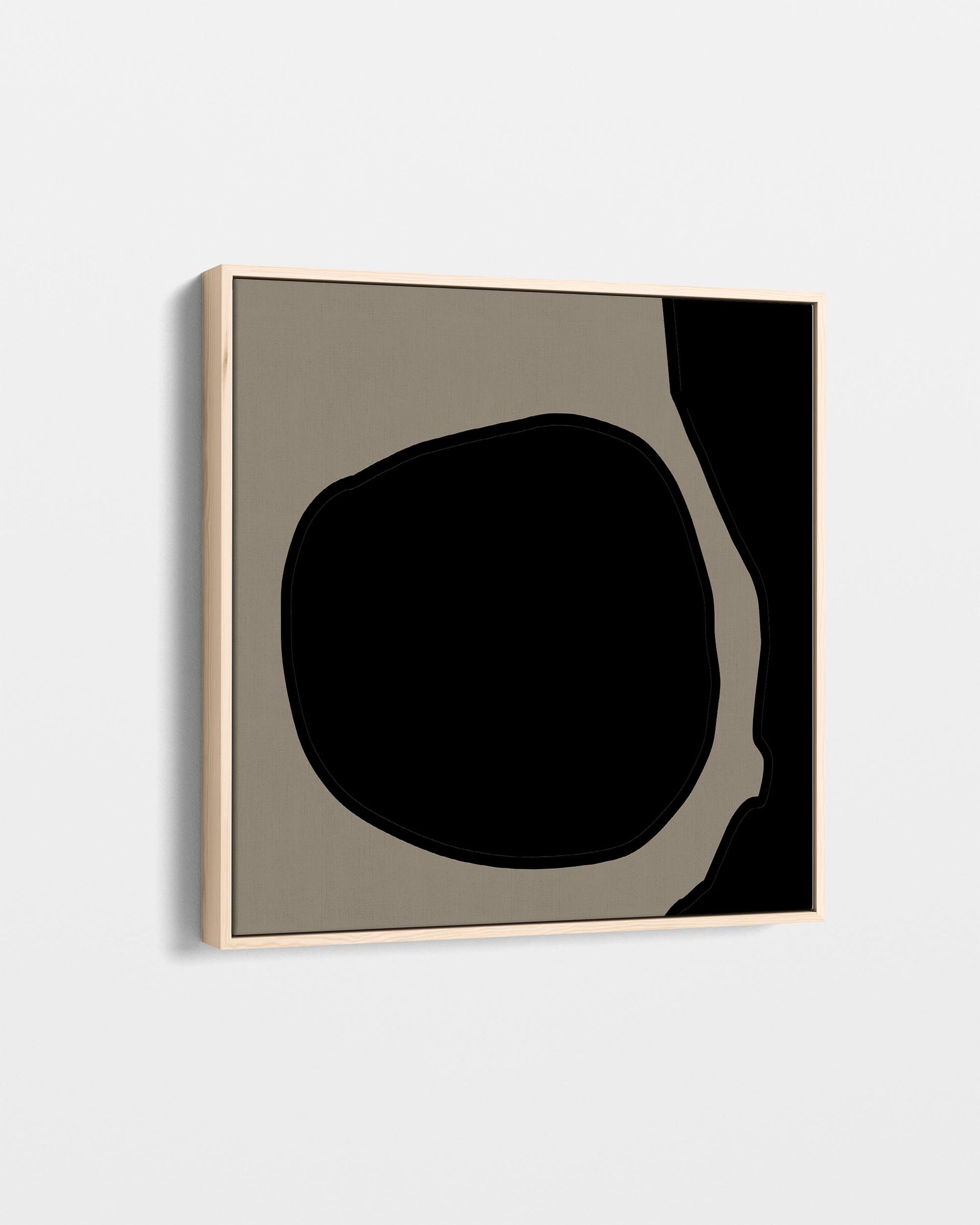 Abstract art piece with a black and beige shape on a light gray background