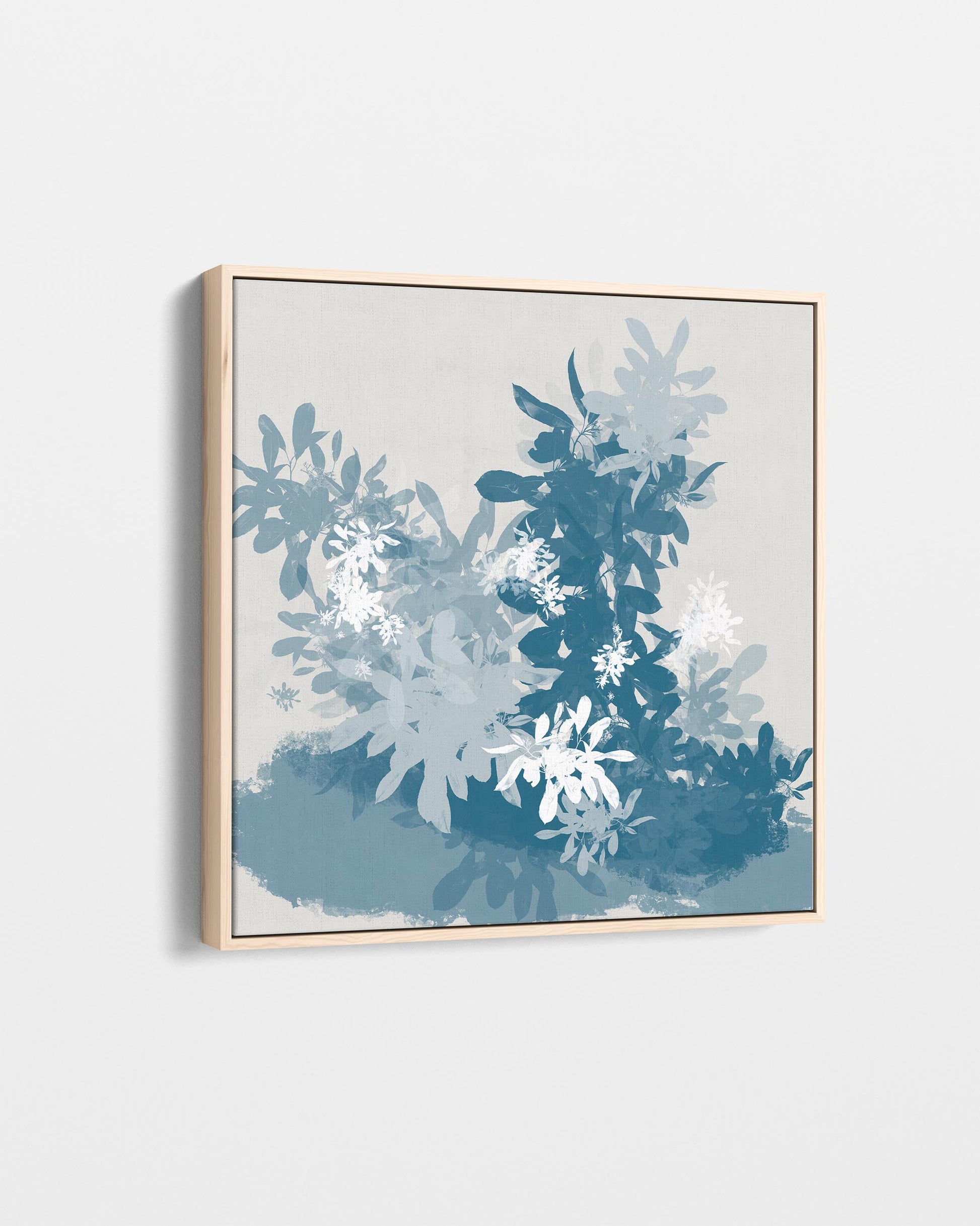 Framed artwork with blue and white abstract design on a light gray background