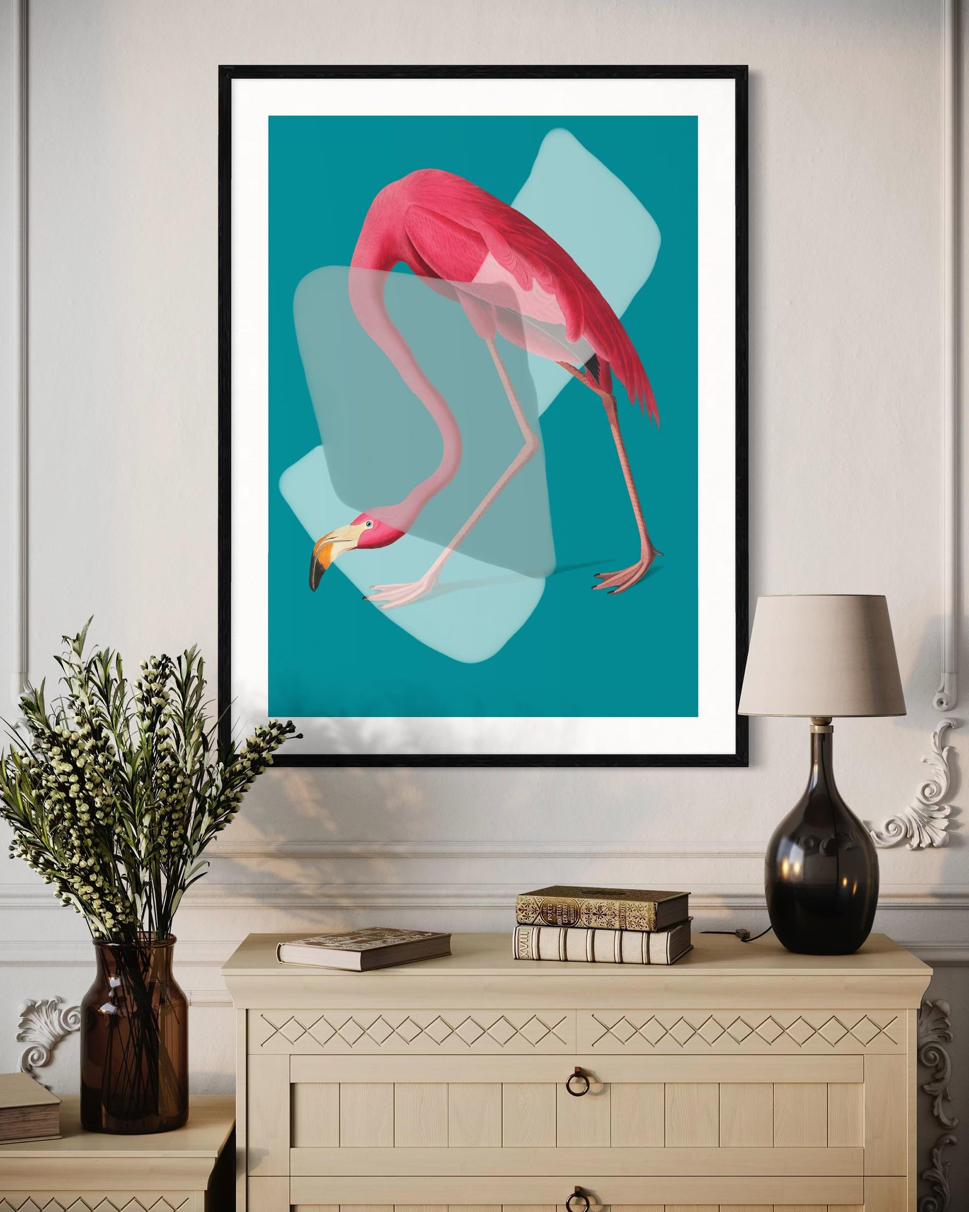 Framed artwork of a pink flamingo on a teal background in a living room setting.